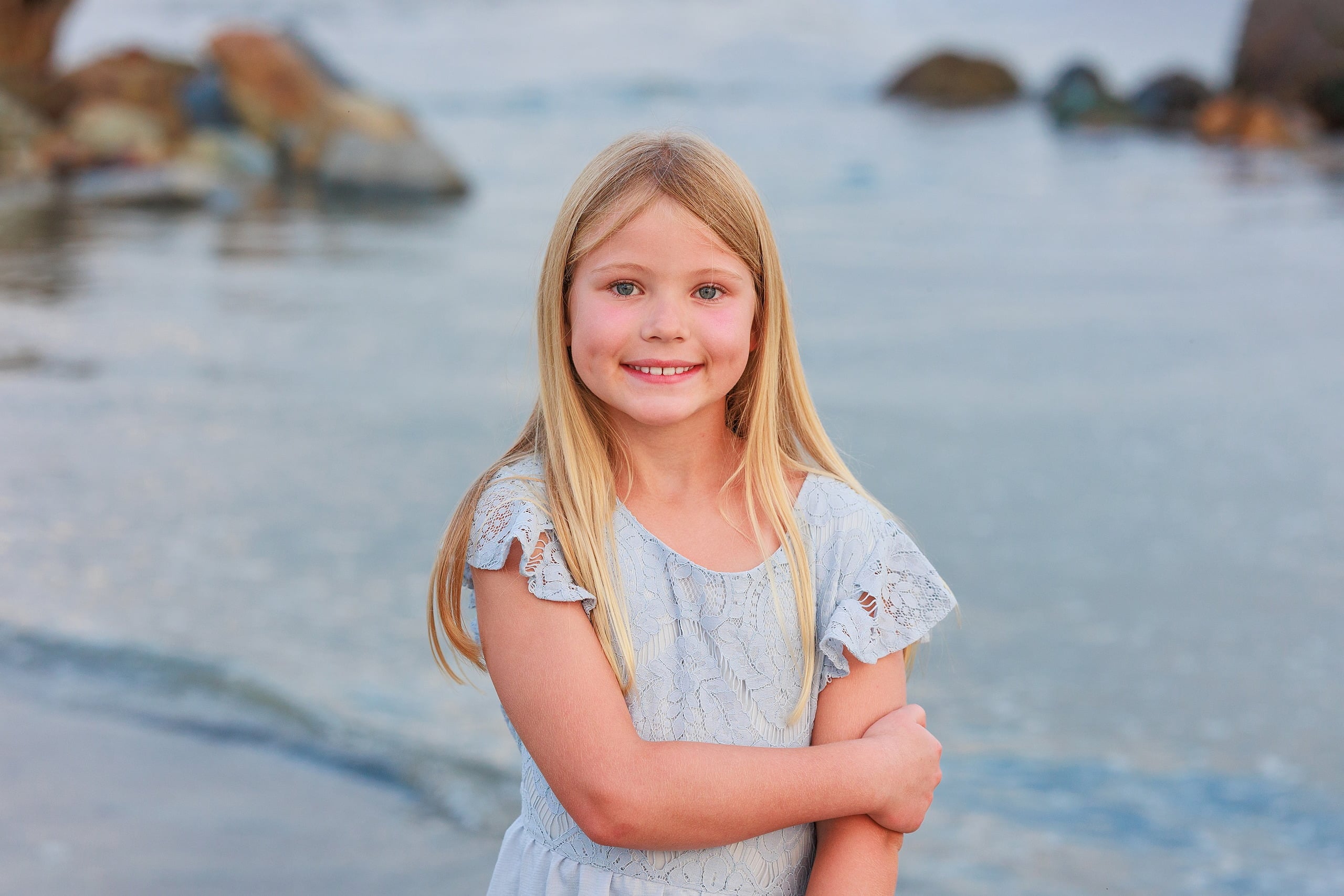 Extended Family Photography Hotel Del Coronado — 18 Child in light lavender dress smiles while standing on Coronado beach