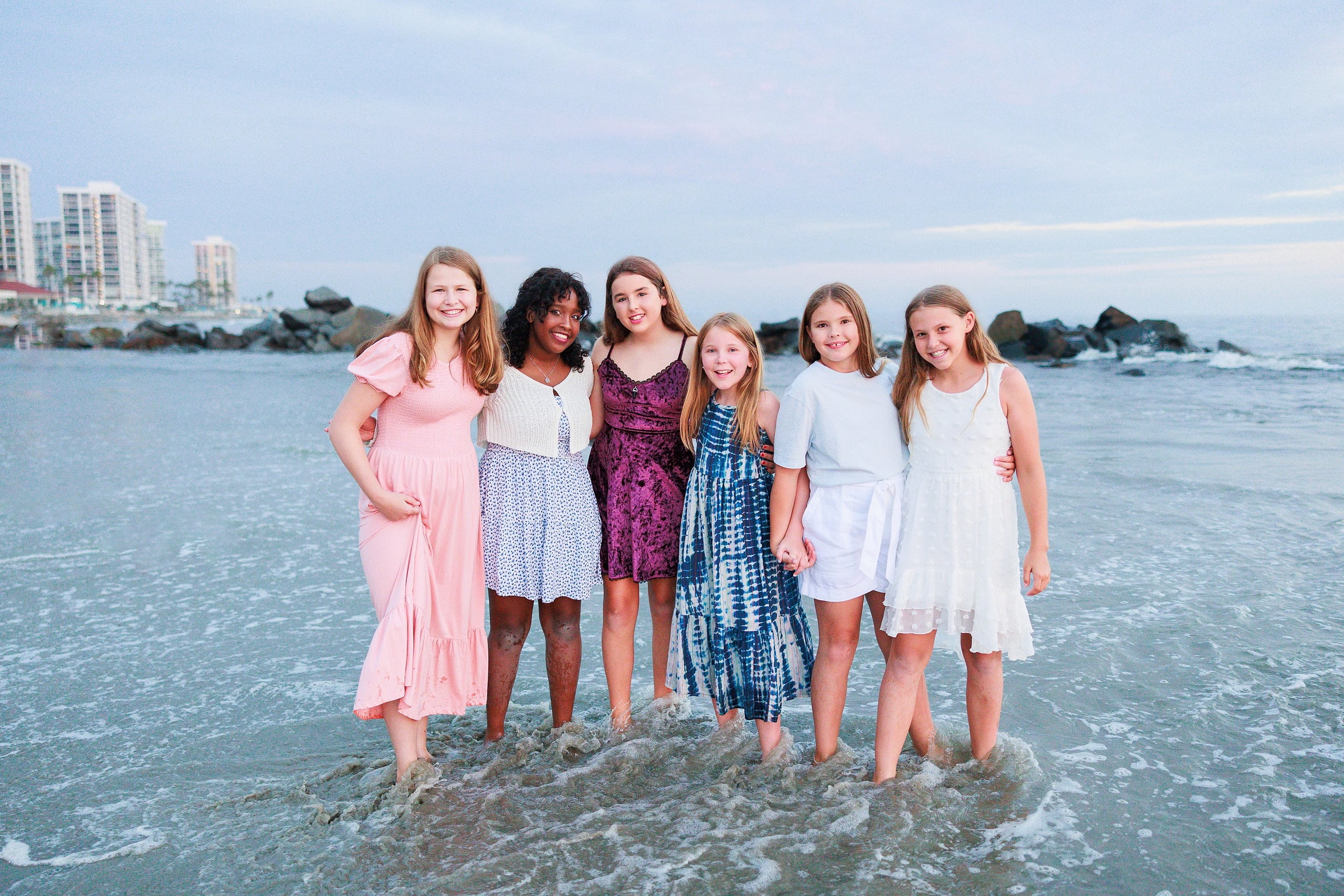 Extended Family Photography Hotel Del Coronado — 24 Group of girls and young adults wade together in shallow ocean water