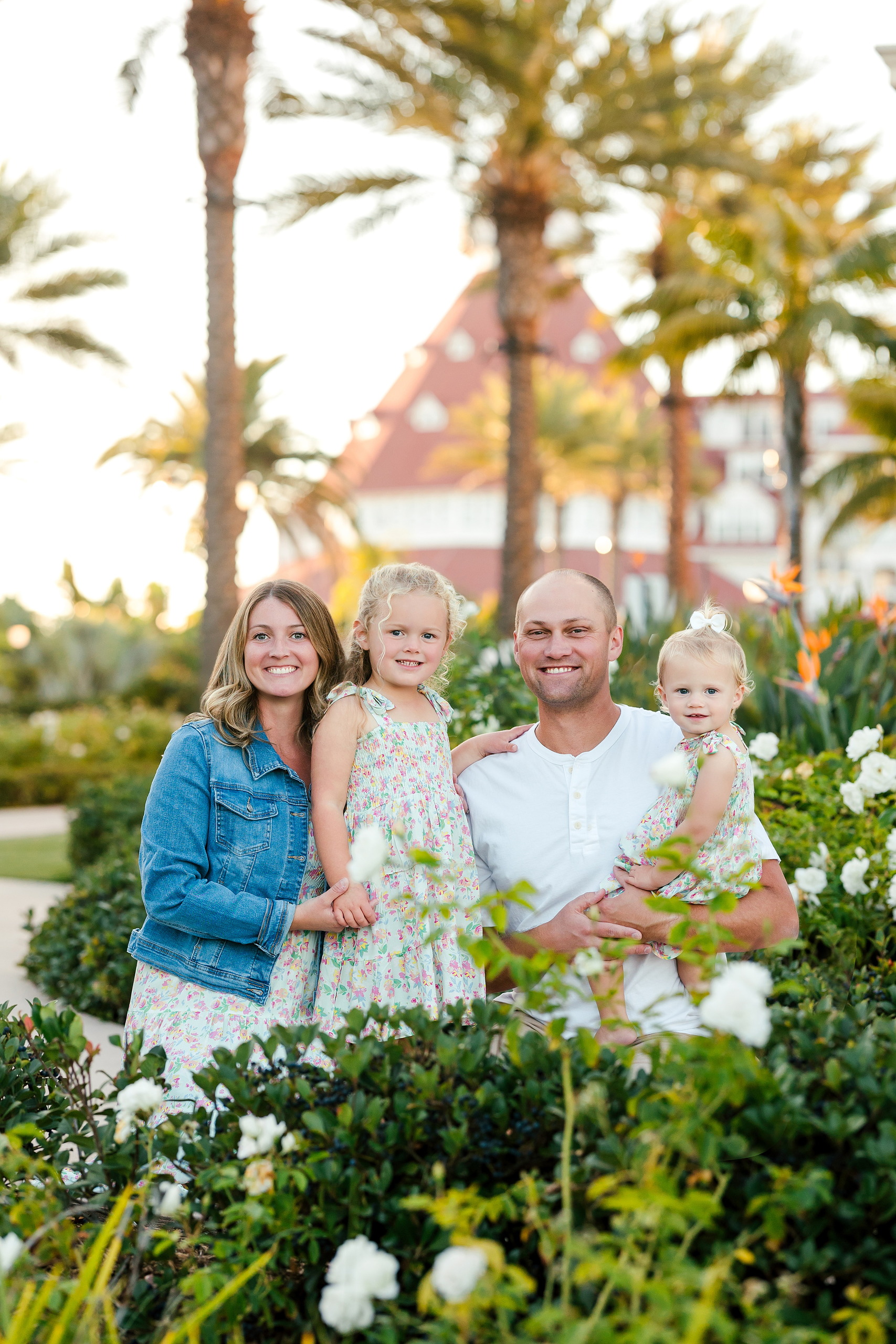 Hotel del Coronado Family Photos — 01 Hanna and her family smiling in Hotel del Coronado's lush gardens