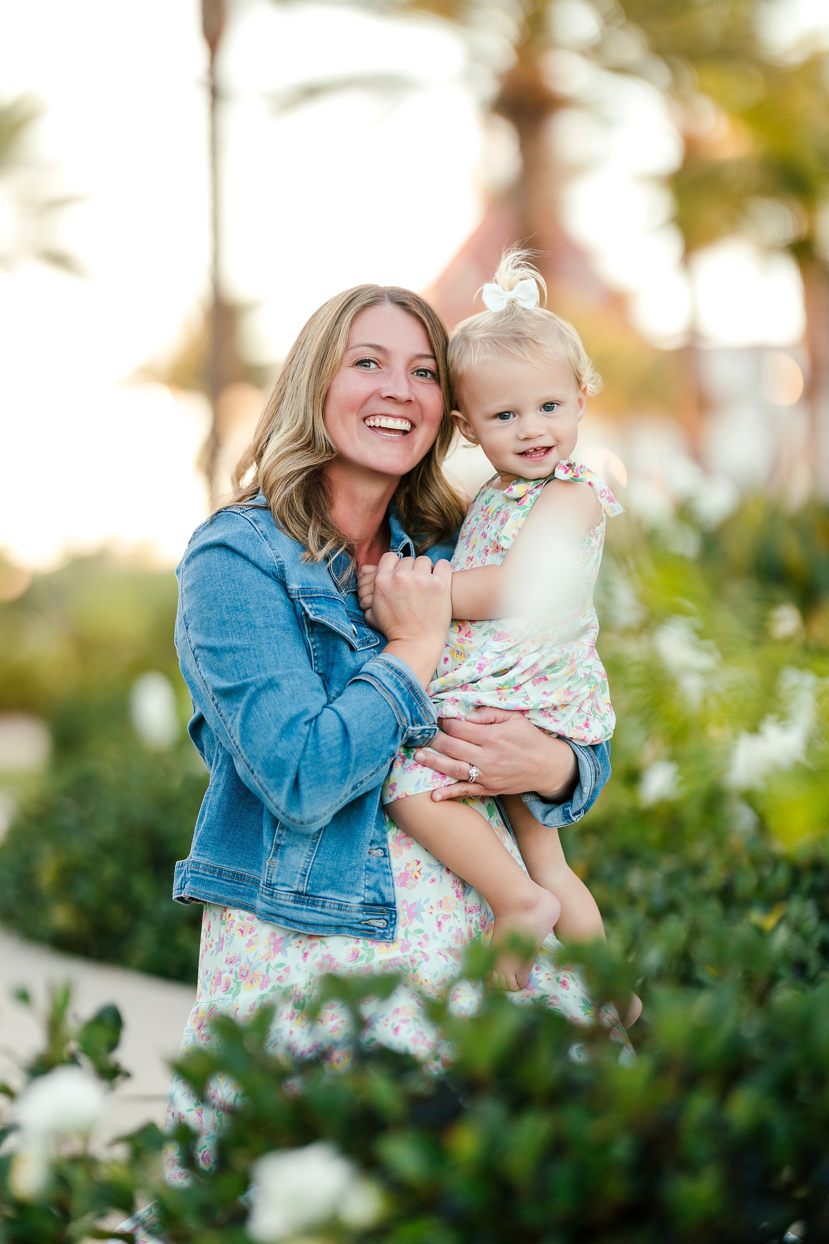 Hotel del Coronado Family Photos — 03 Hanna holding Mabel while smiling in the Hotel del Coronado garden