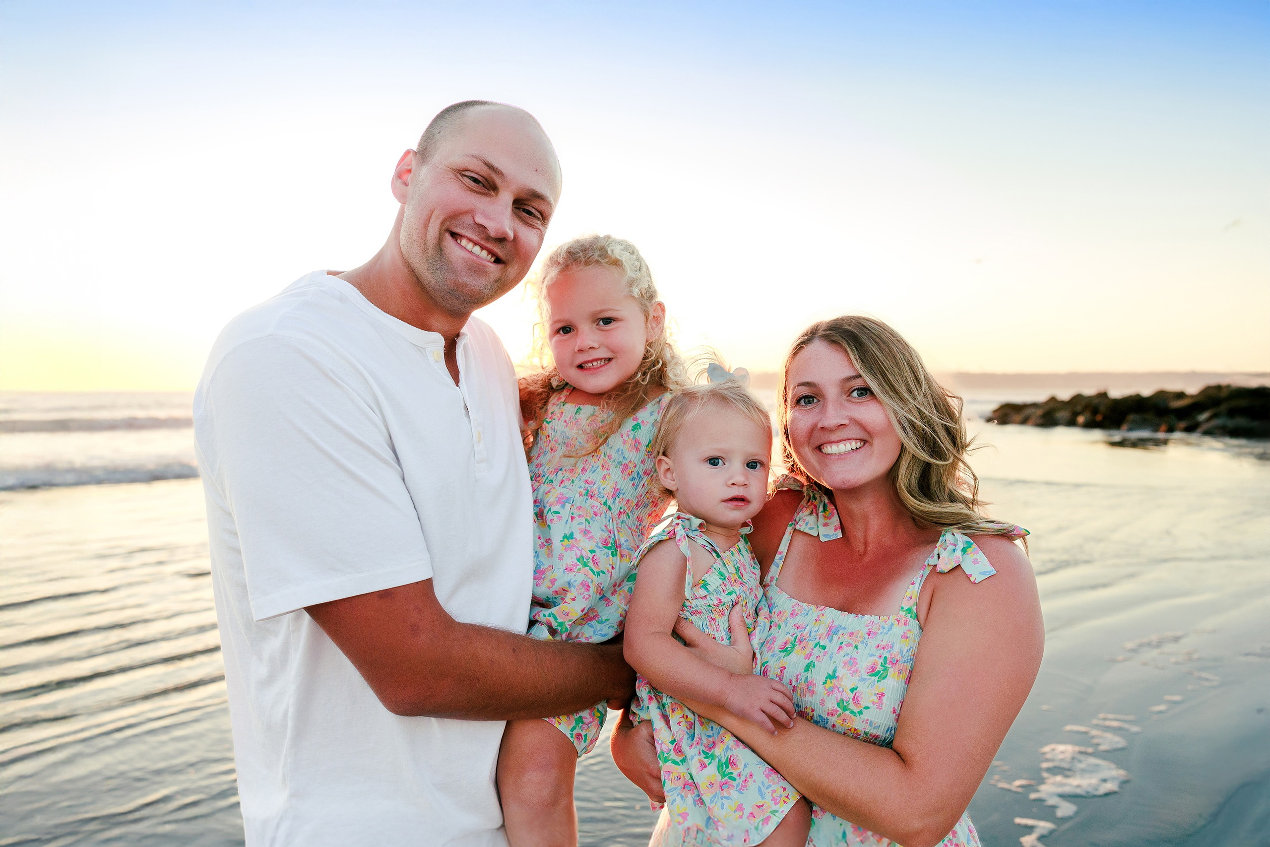 Hotel del Coronado Family Photos — 12 Father playfully lifting toddler high on the beach at sunset
