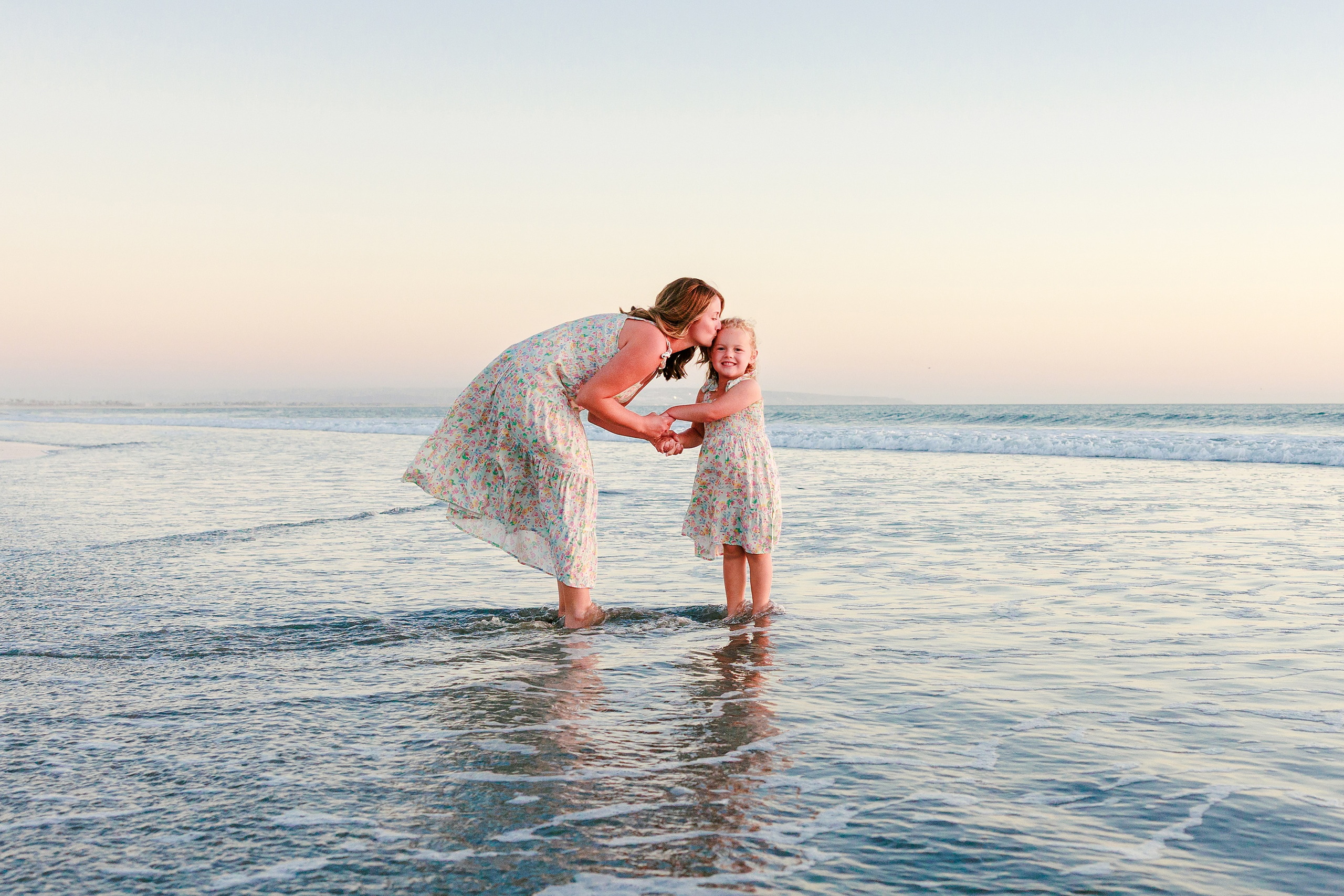 Hotel del Coronado Family Photos — 19 Father kissing Mabel on the beach at Coronado during golden hour