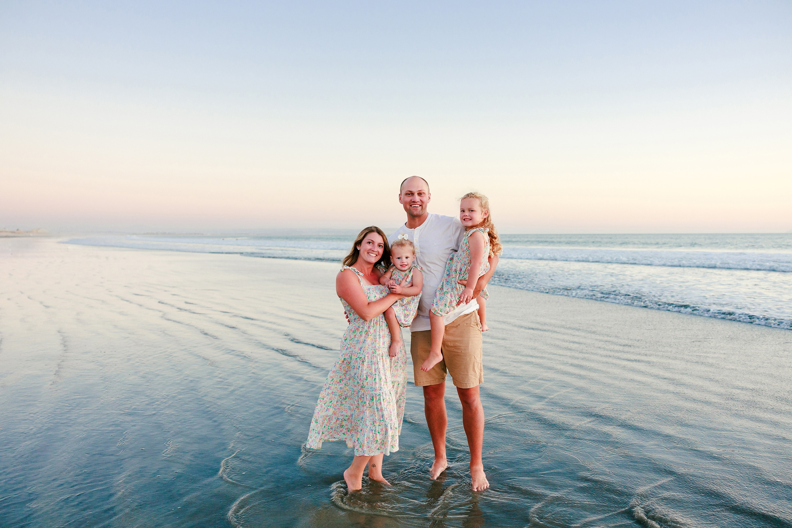 Hotel del Coronado Family Photos — 22 Family of four walking hand-in-hand in shallow water at Coronado beach