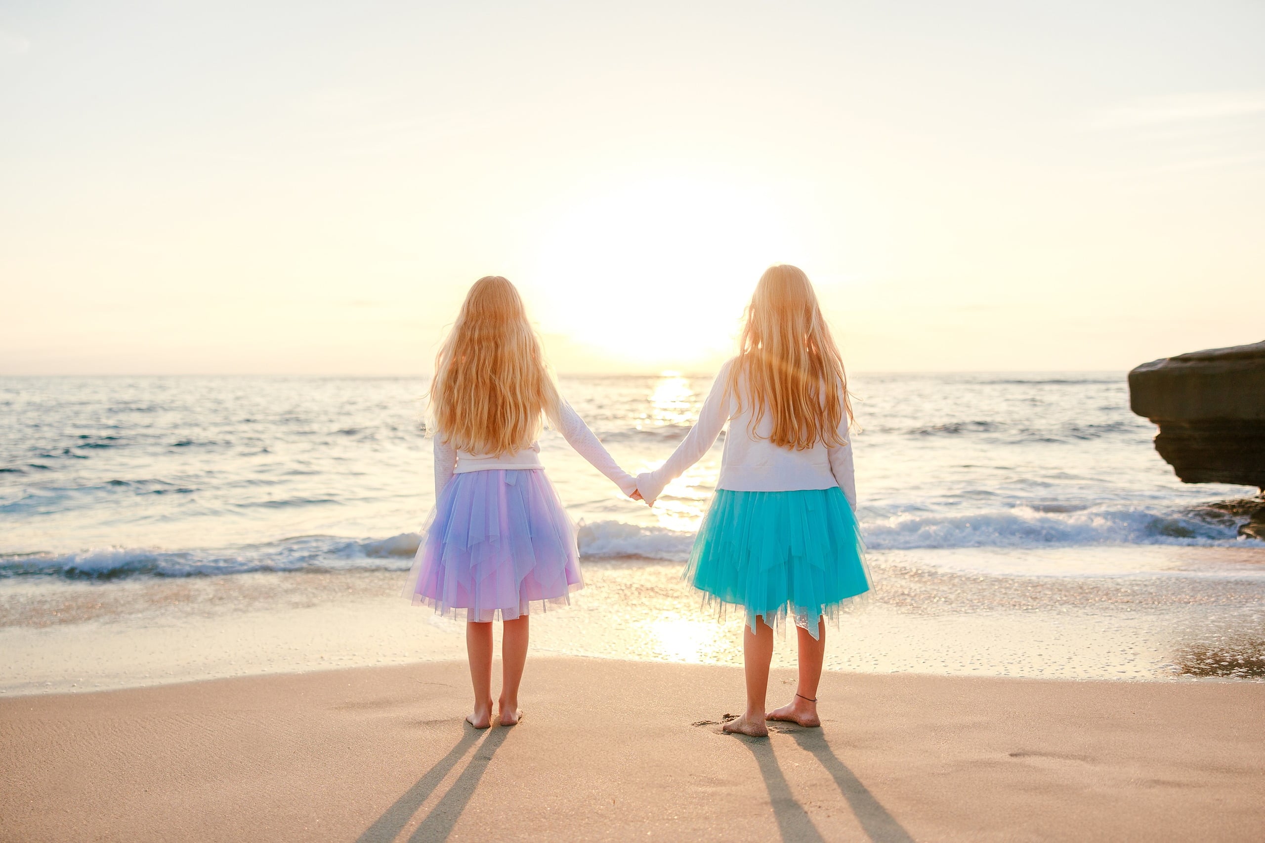La Jolla Family Photography — 19 Two children holding hands on beach, one in purple tulle, one in turquoise