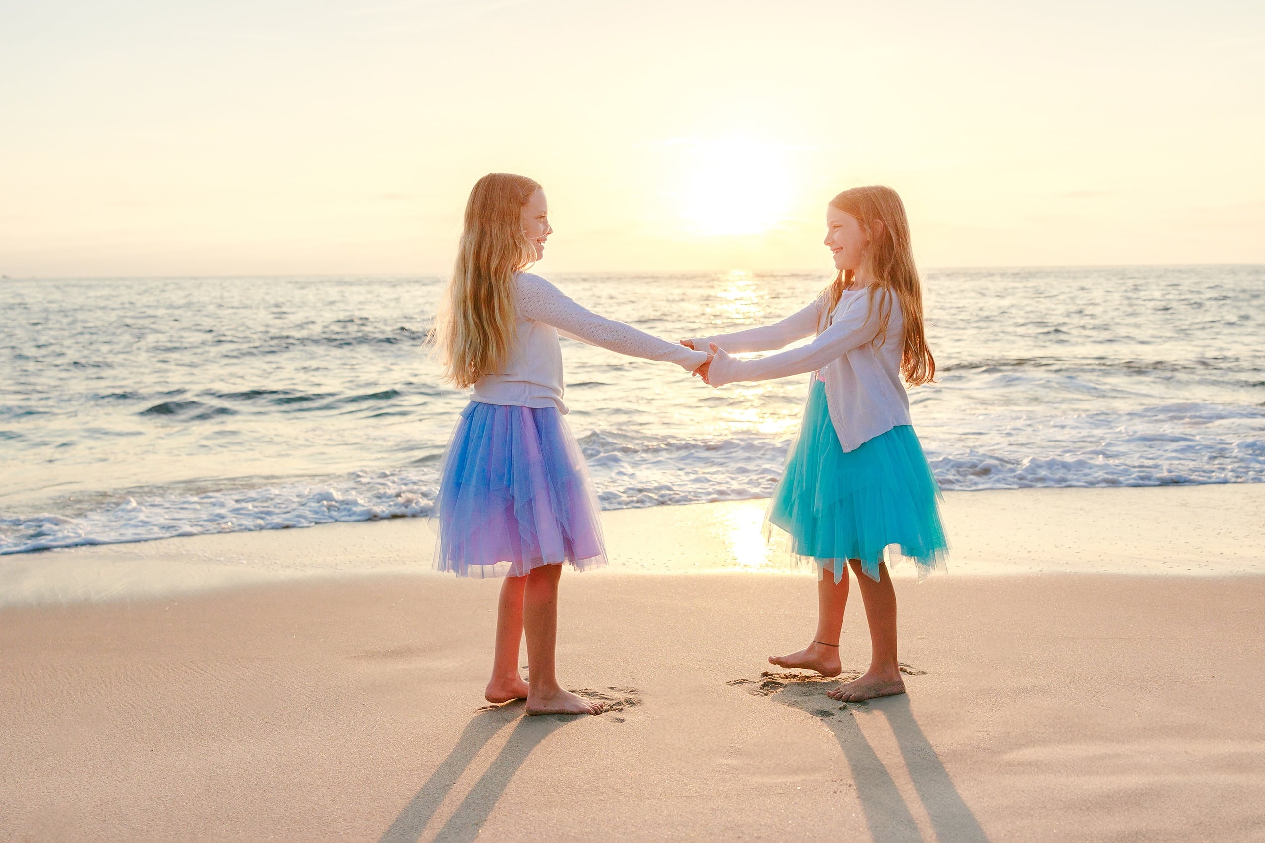 La Jolla Family Photography — 20 Two children holding hands on wet sand at golden hour on beach