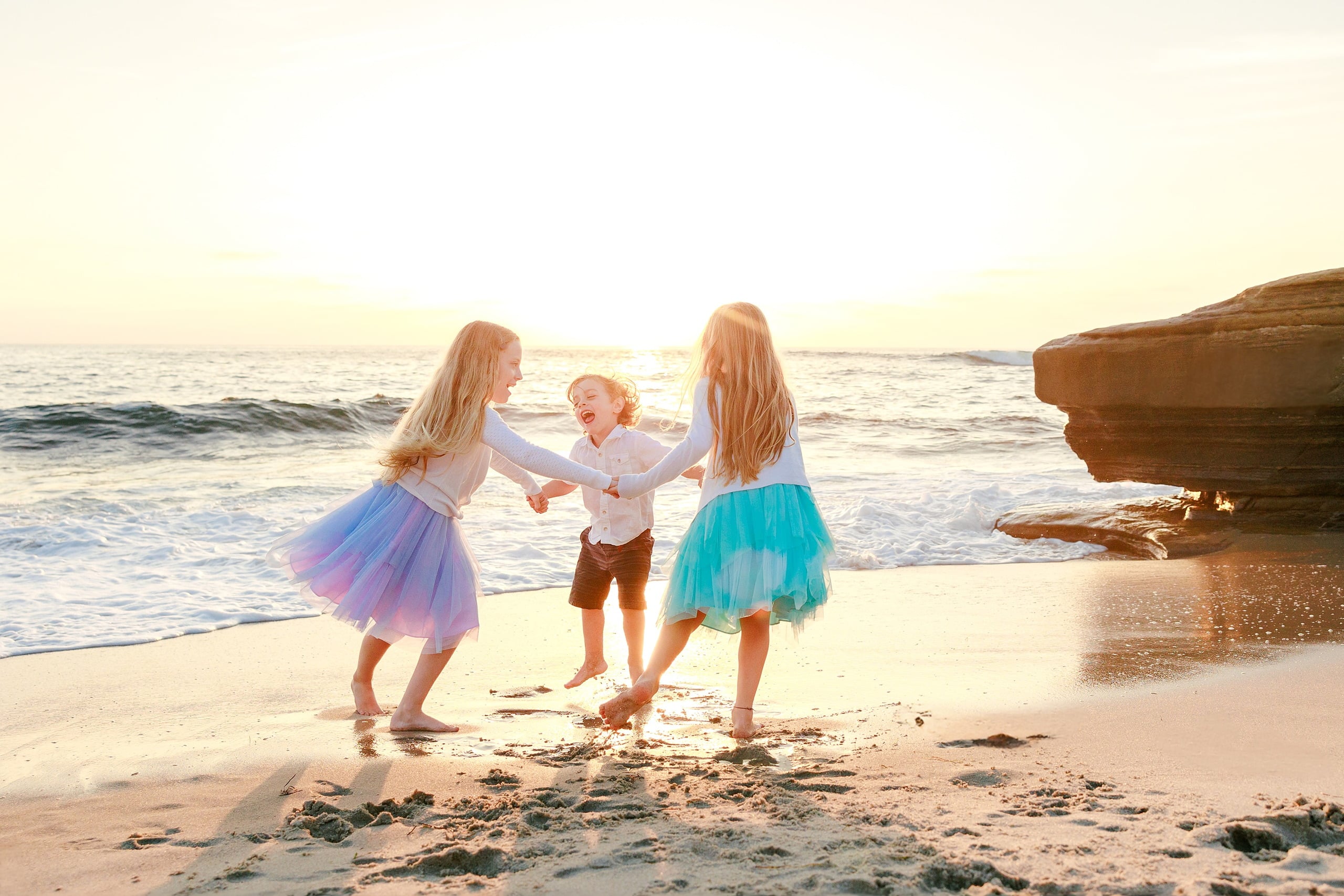 La Jolla Family Photography — 26 Three children on beach, toddler in center with two older children on either side