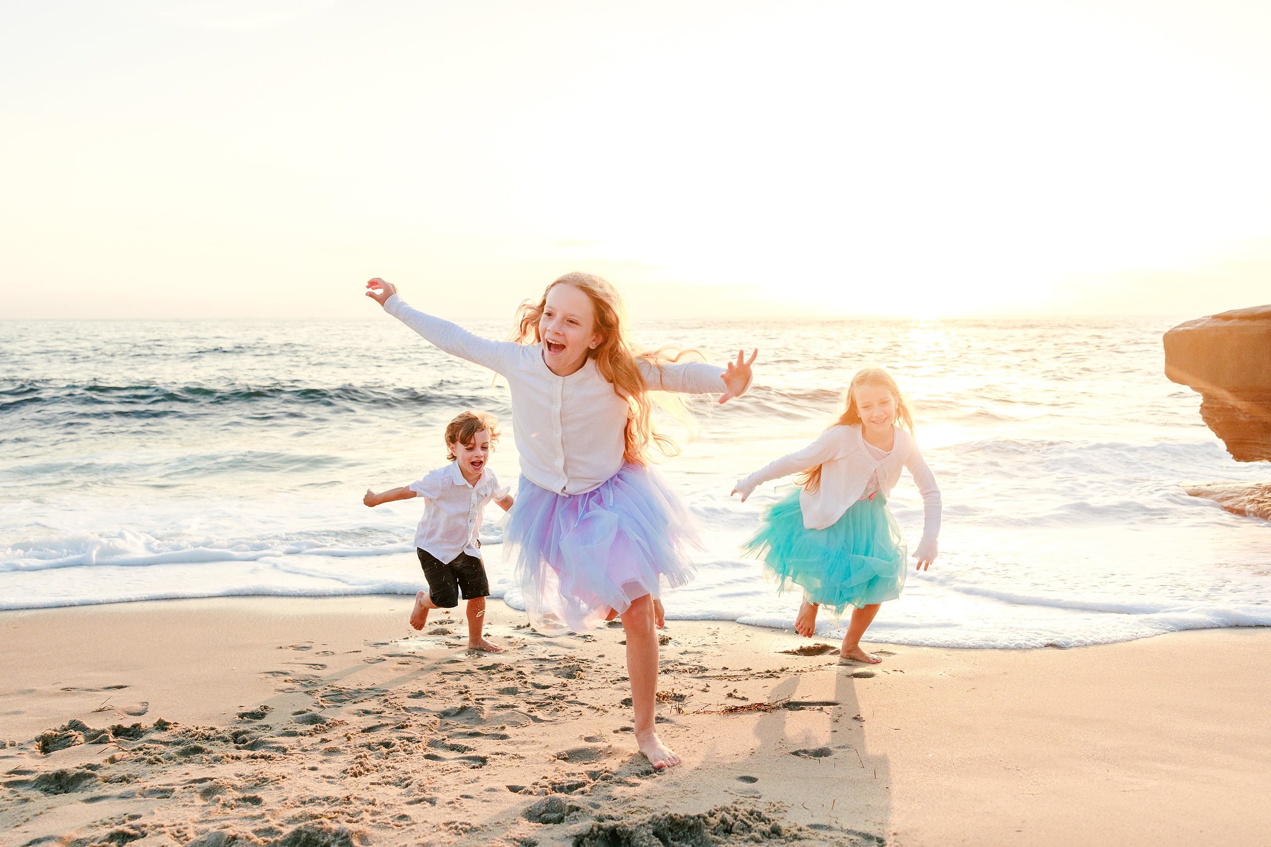 La Jolla Family Photography — 27 Three children running on beach with arms outstretched