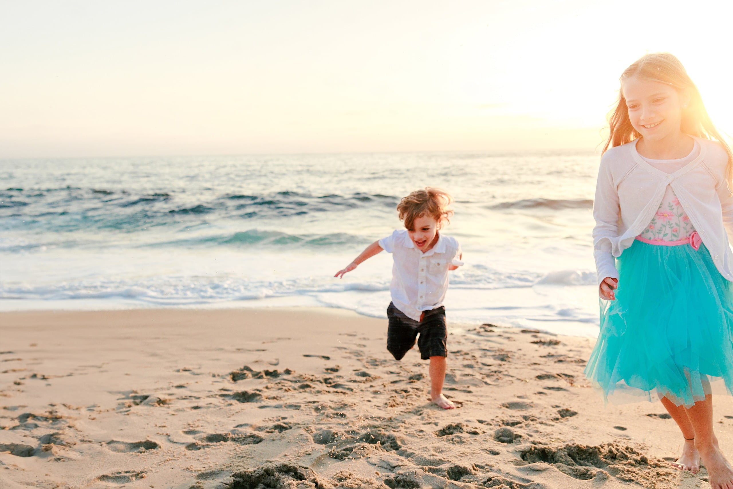 La Jolla Family Photography — 29 Toddler running on beach between two older girls