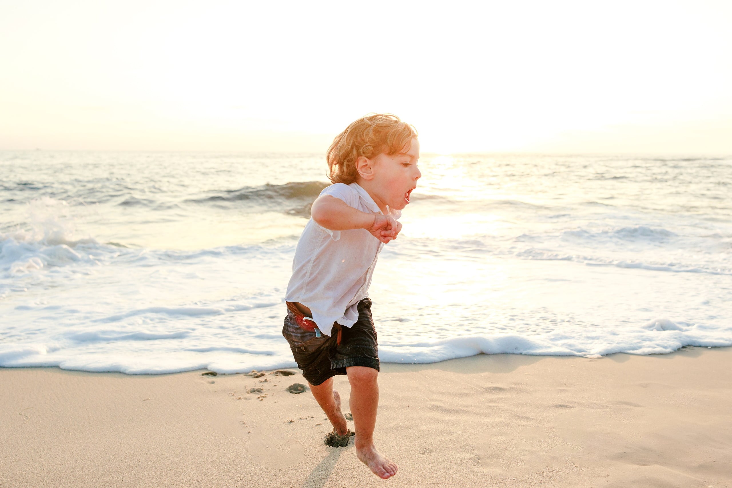 La Jolla Family Photography — 33 Toddler in white shirt running on beach at sunset