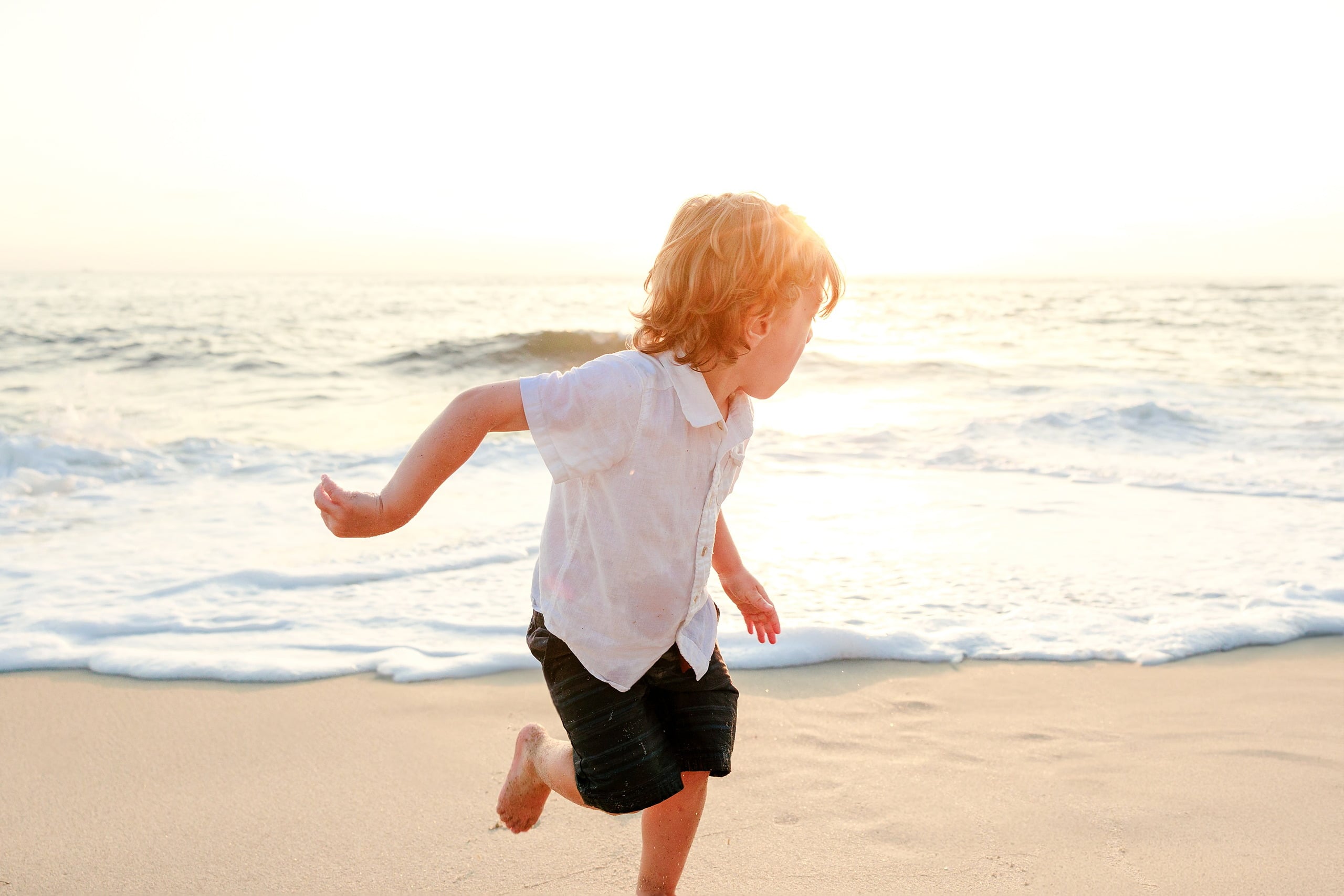 La Jolla Family Photography — 34 Toddler running on beach with expression of concentration