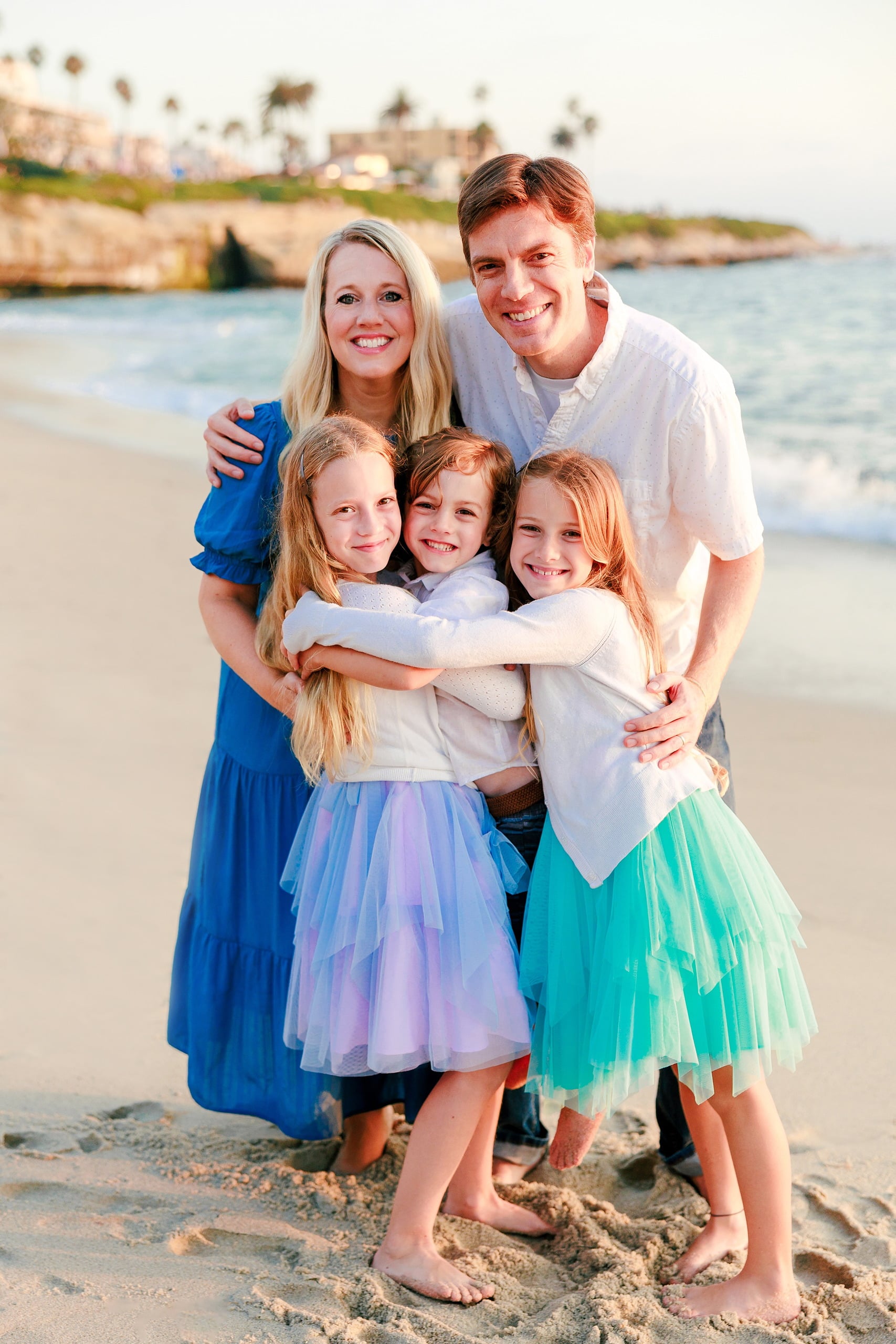 La Jolla Family Photography — 38 Family portrait with woman, man, and three daughters in tutus on beach