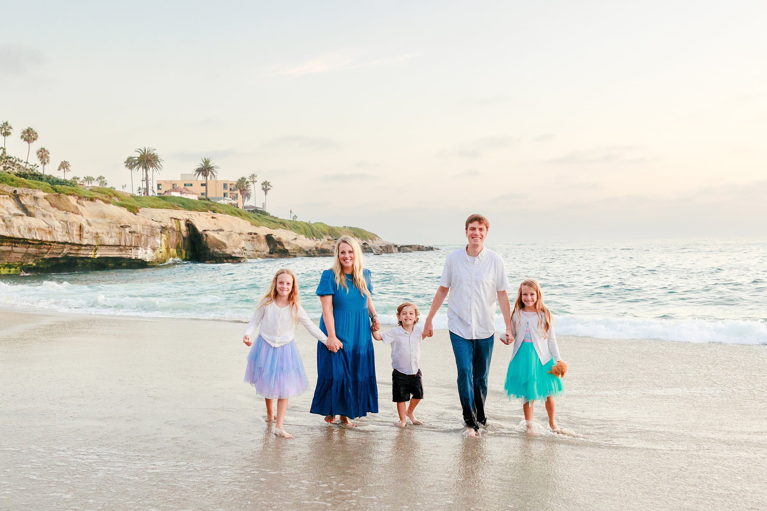 La Jolla Family Photography — 48 Family standing in wet sand on beach with children in various colored tutus
