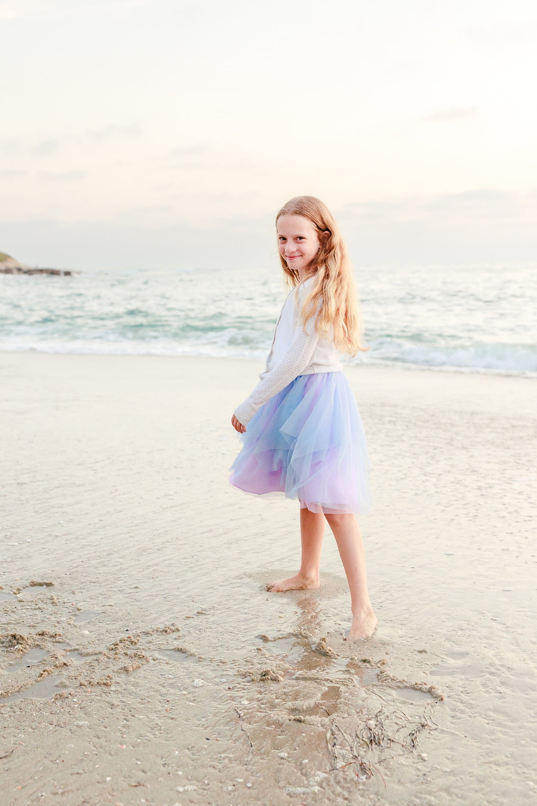 La Jolla Family Photography — 57 Girl in white long-sleeve and light purple tulle walking on beach