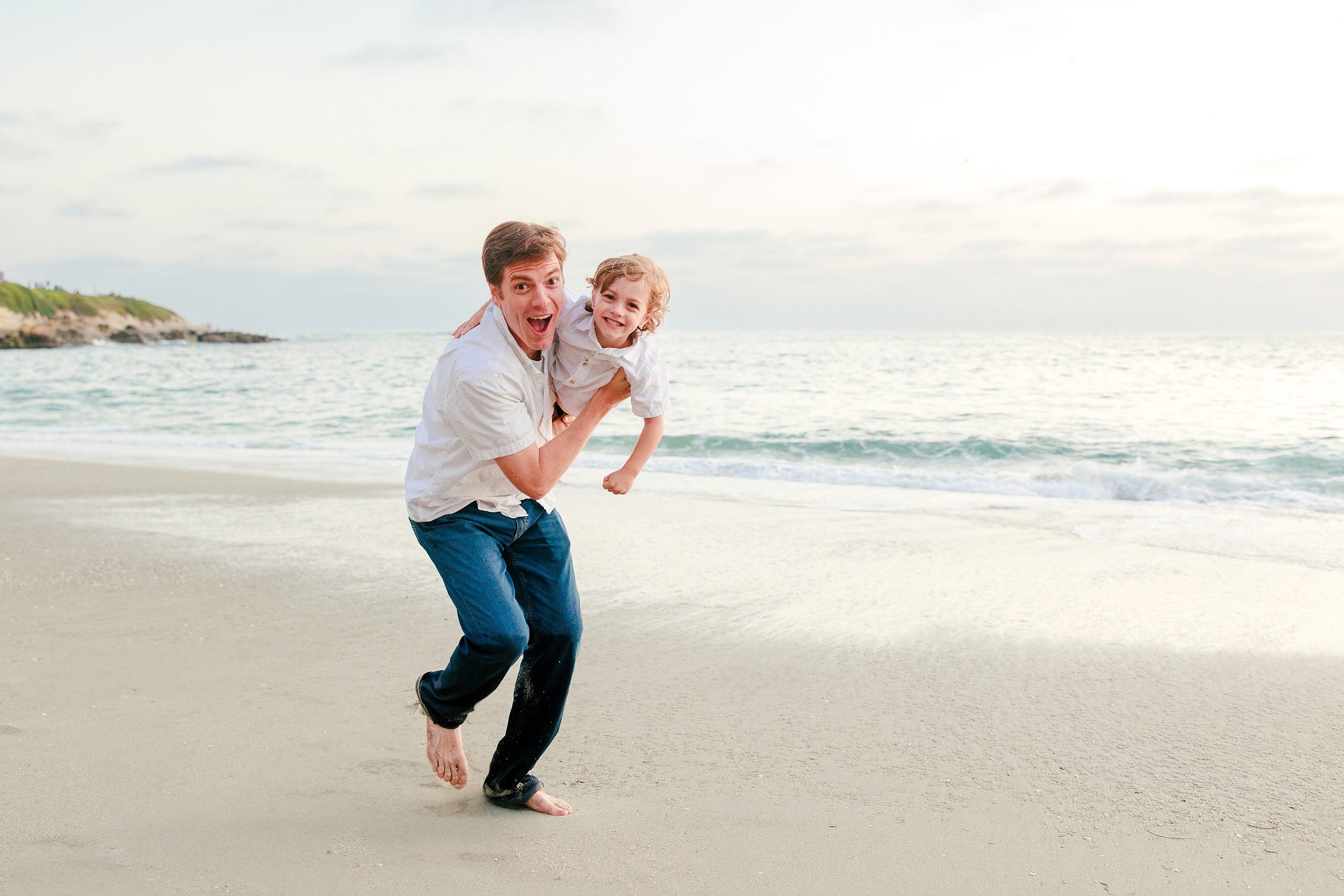 La Jolla Family Photography — 62 Man holding toddler running on beach together