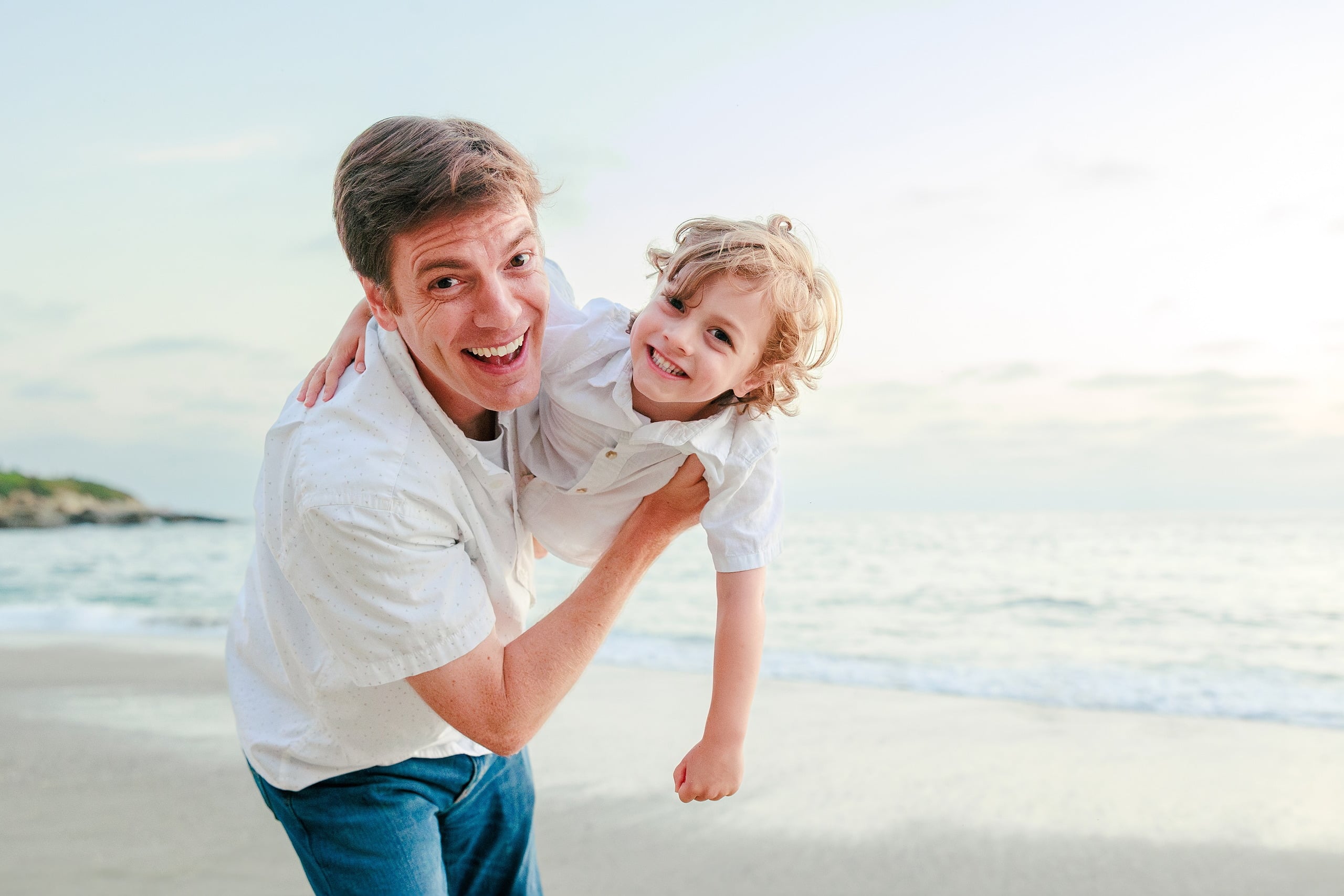 La Jolla Family Photography — 63 Man holding toddler on beach, both smiling at camera