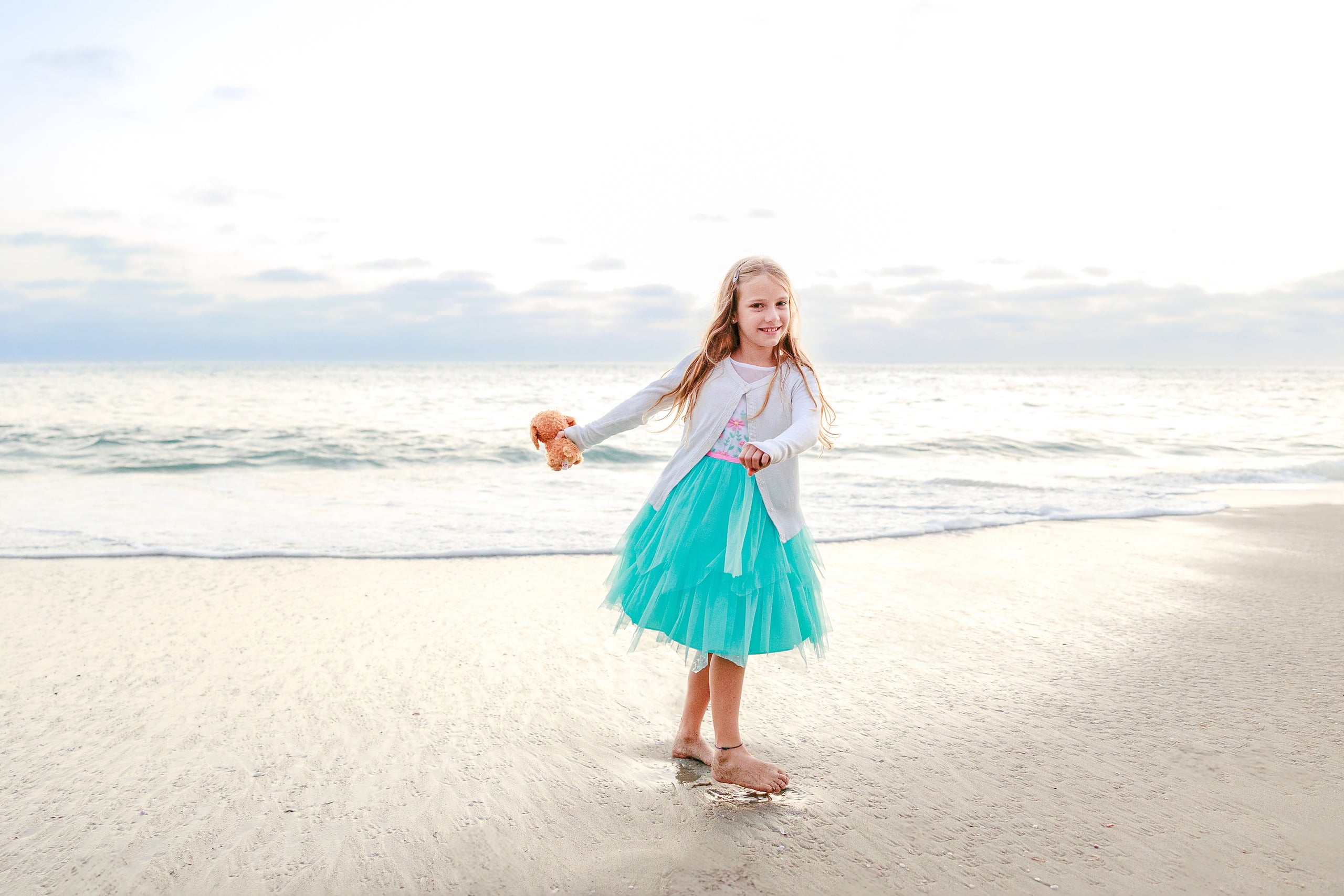 La Jolla Family Photography — 66 Girl in white cardigan and turquoise tulle standing on beach