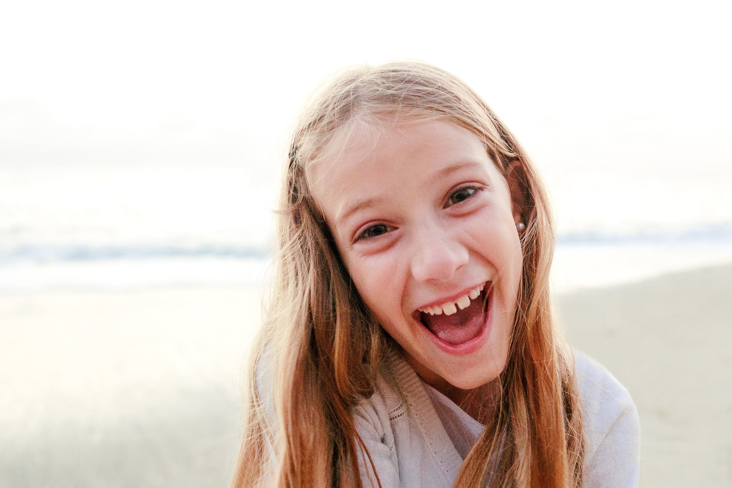 La Jolla Family Photography — 71 Close-up portrait of girl laughing on beach