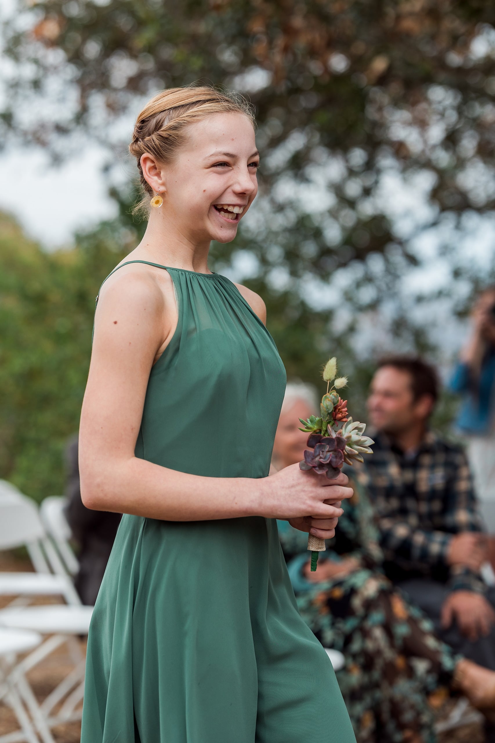 Moriah & Greg’s Wedding — 14 Groom Greg stands beside his bride among living succulent plants in the garden venue