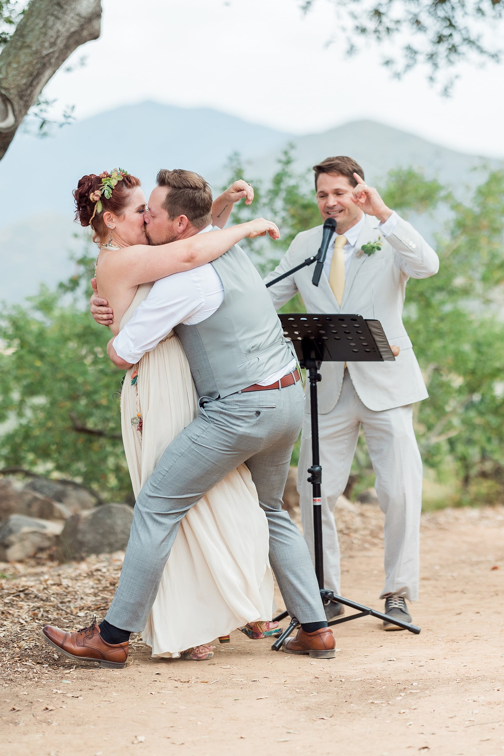 Moriah & Greg’s Wedding — 42 Groom lifts his bride in a joyful dance move, both laughing in the garden atmosphere