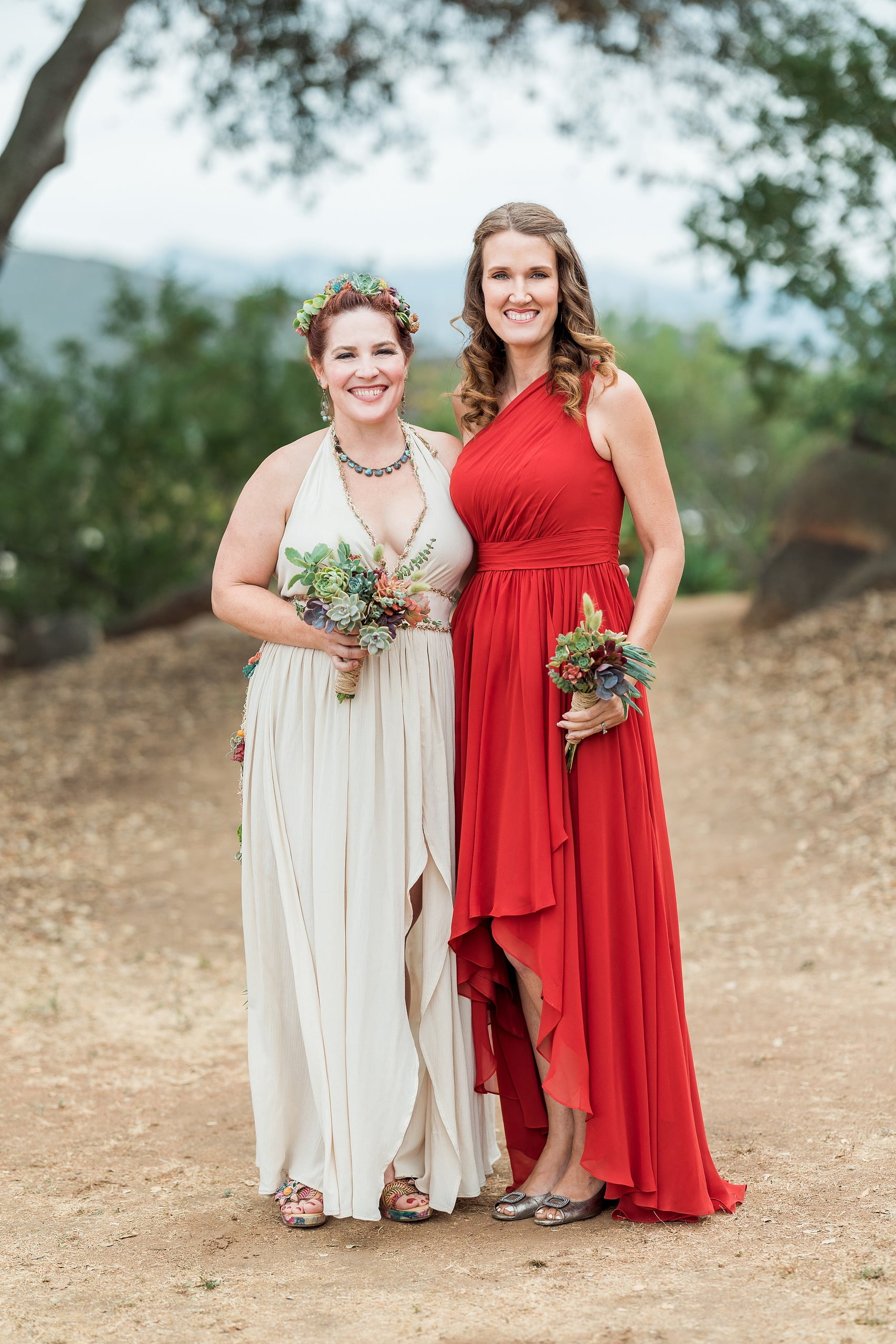 Moriah & Greg’s Wedding — 69 Bride and groom kiss, surrounded by lush succulent landscape and celebrating guests