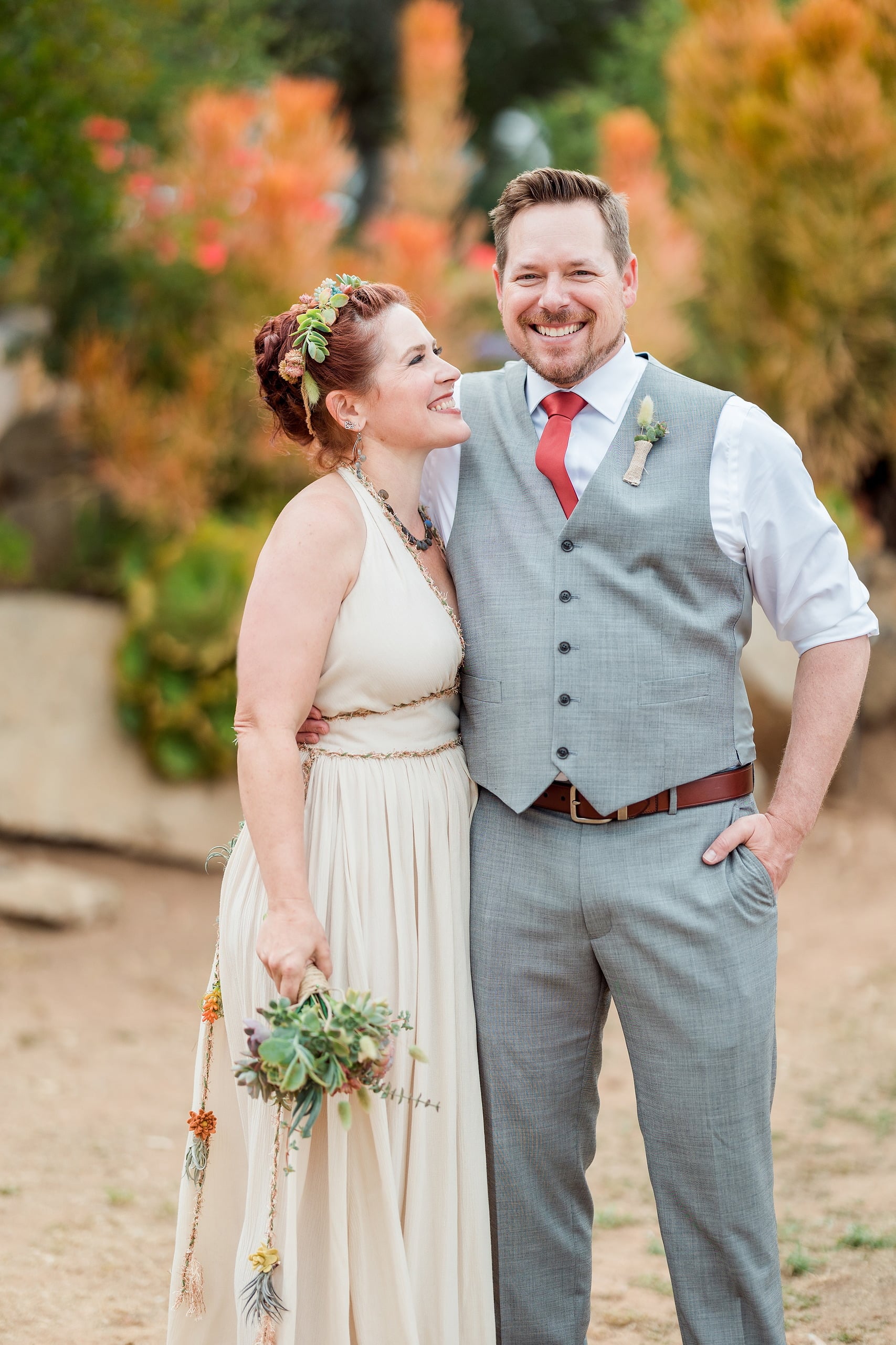 Moriah & Greg’s Wedding — 90 Close-up detail of bride's succulent crown and smiling face during joyful garden moment