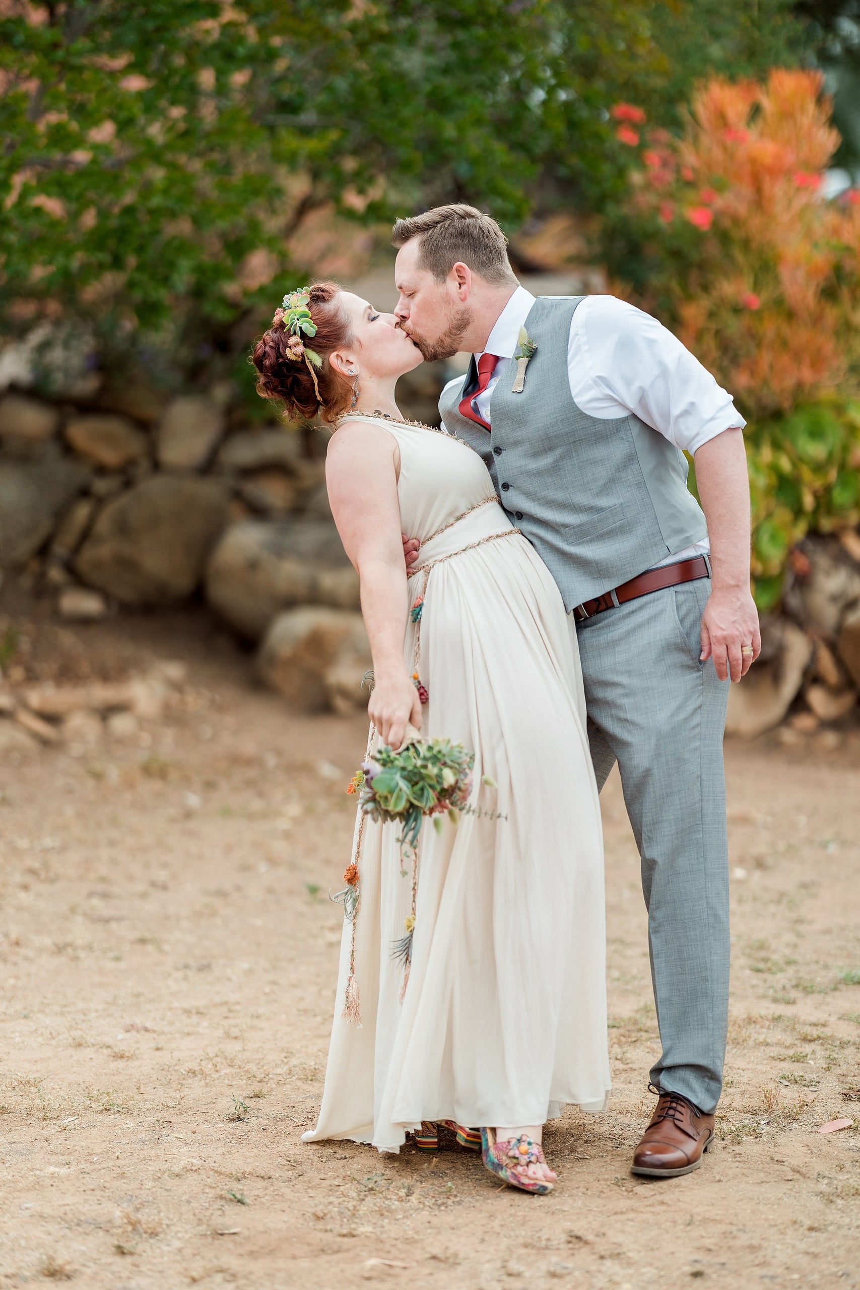 Moriah & Greg’s Wedding — 91 Sister Melanie stands beside Moriah, both in wedding attire in San Diego succulent garden