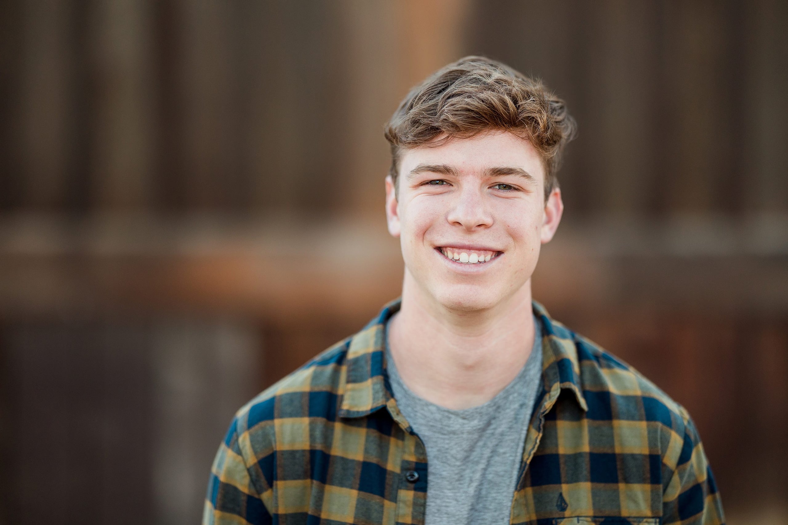 Photographer San Diego — 07 Senior teen boy standing by old structure, looking off to side