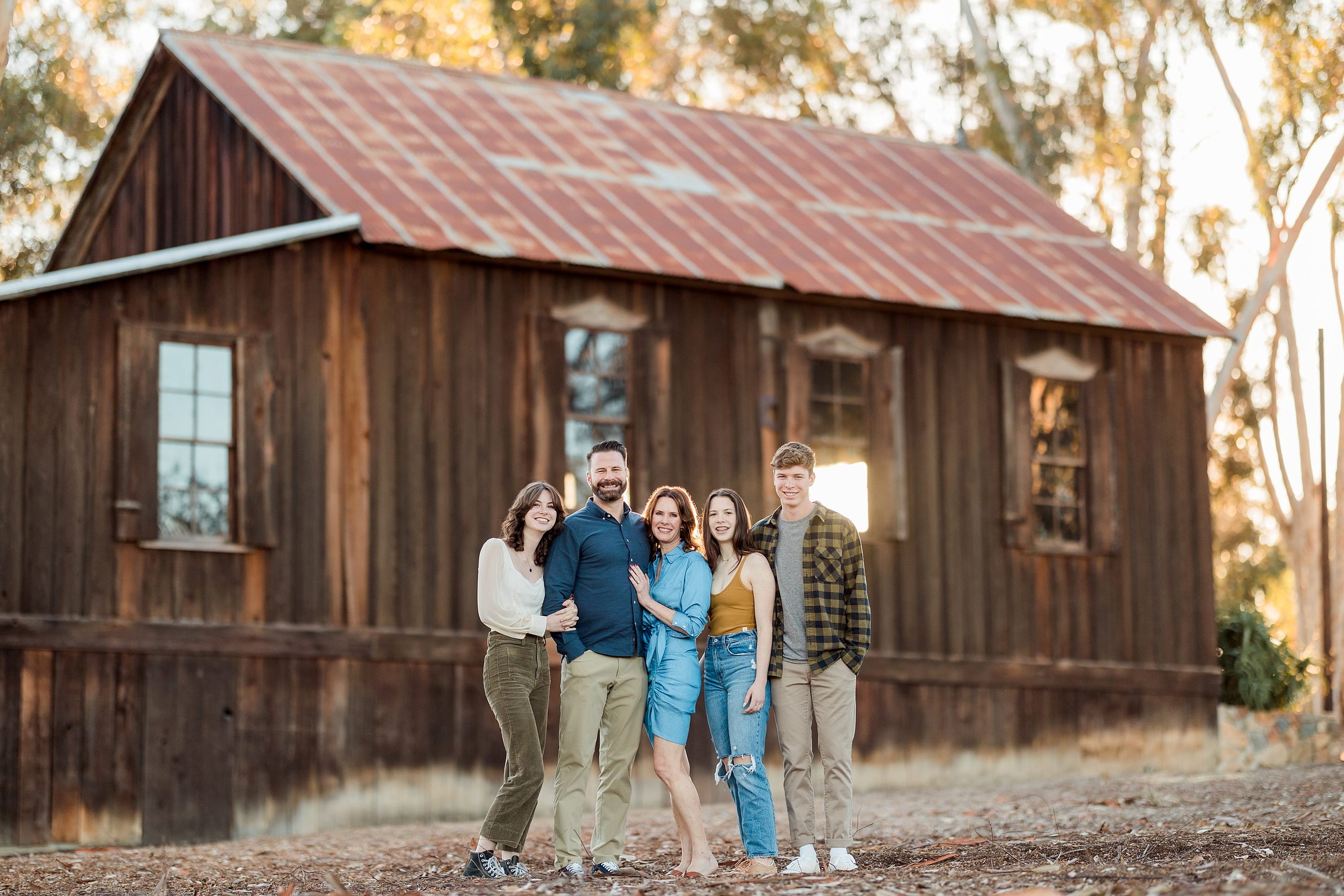 Photographer San Diego — 13 Family of five posed together in front of weathered historic building