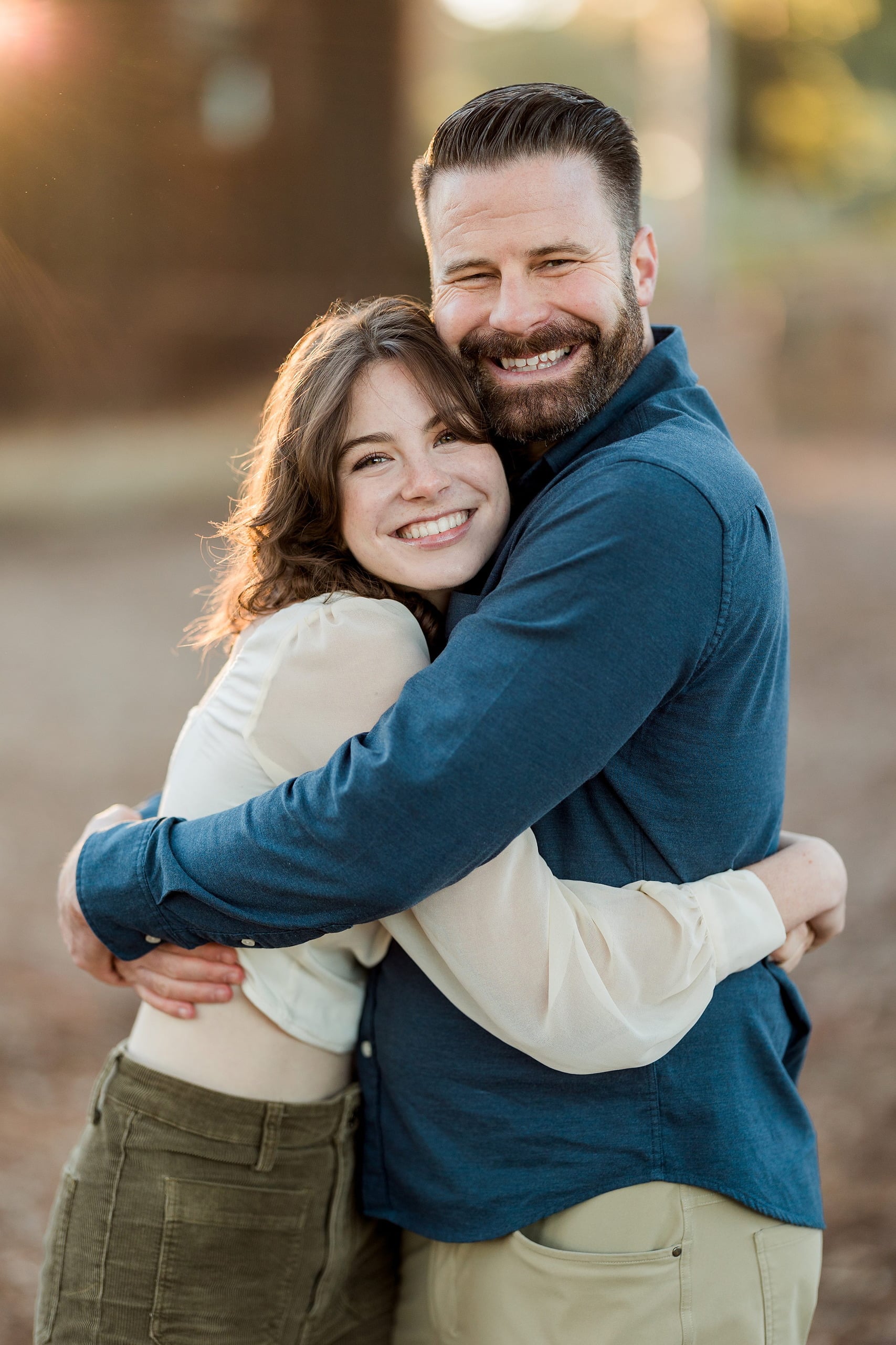 Photographer San Diego — 14 Father and mother hugging outside at the Olivenhain Town Hall building