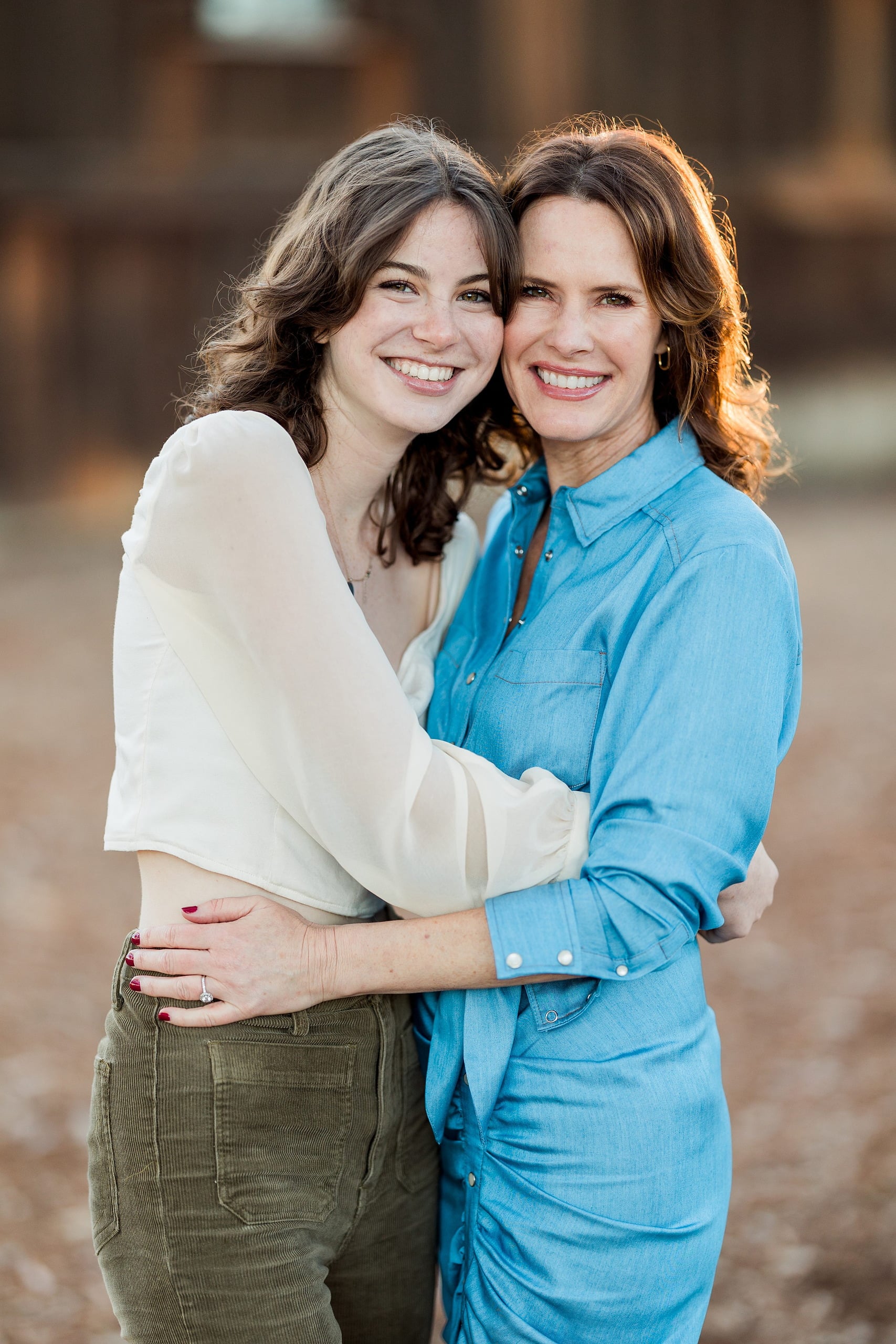 Photographer San Diego — 15 Adult woman and teen daughter hugging closely at wooden setting