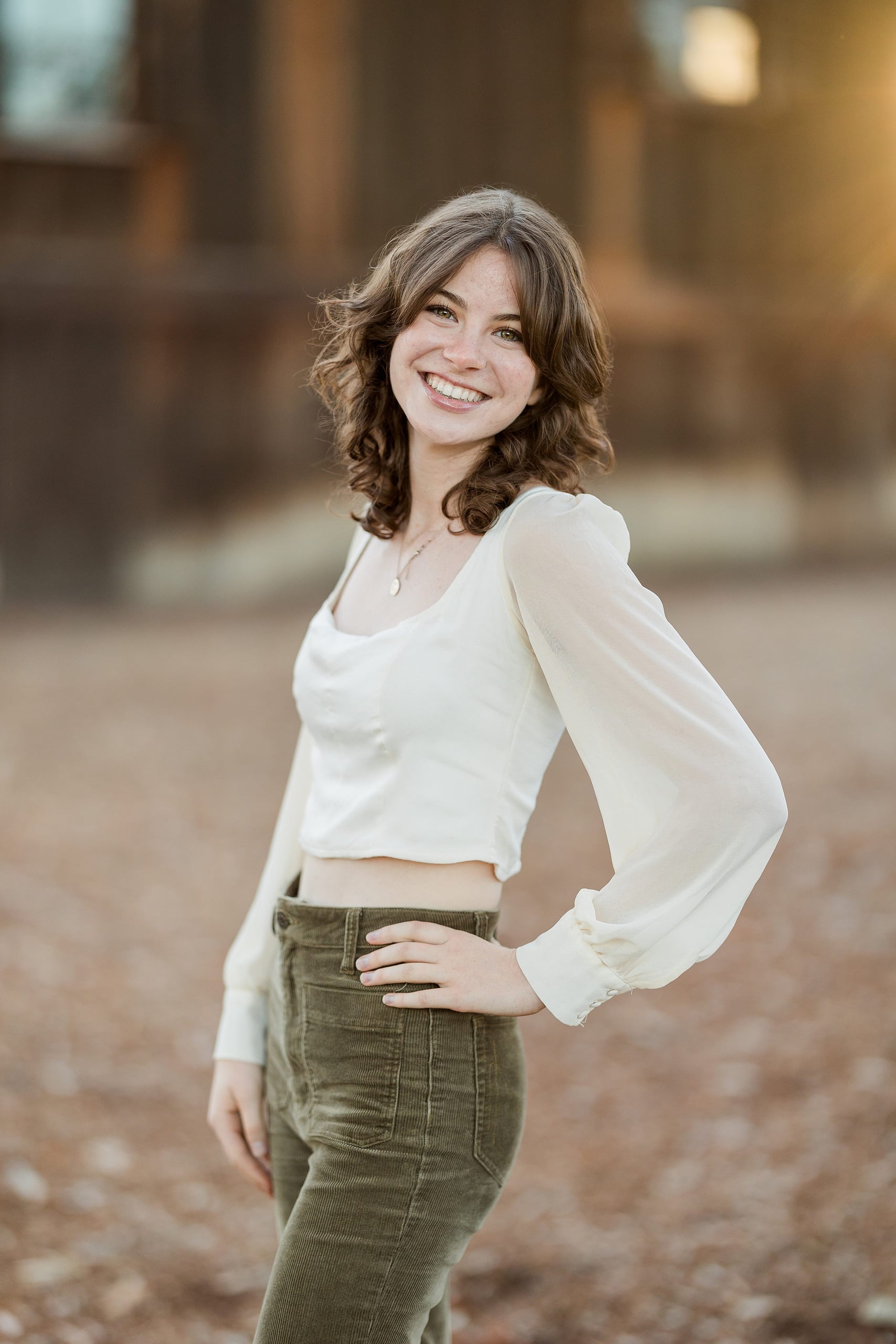 Photographer San Diego — 16 Teen girl in cream long-sleeve shirt standing alone at outdoor location