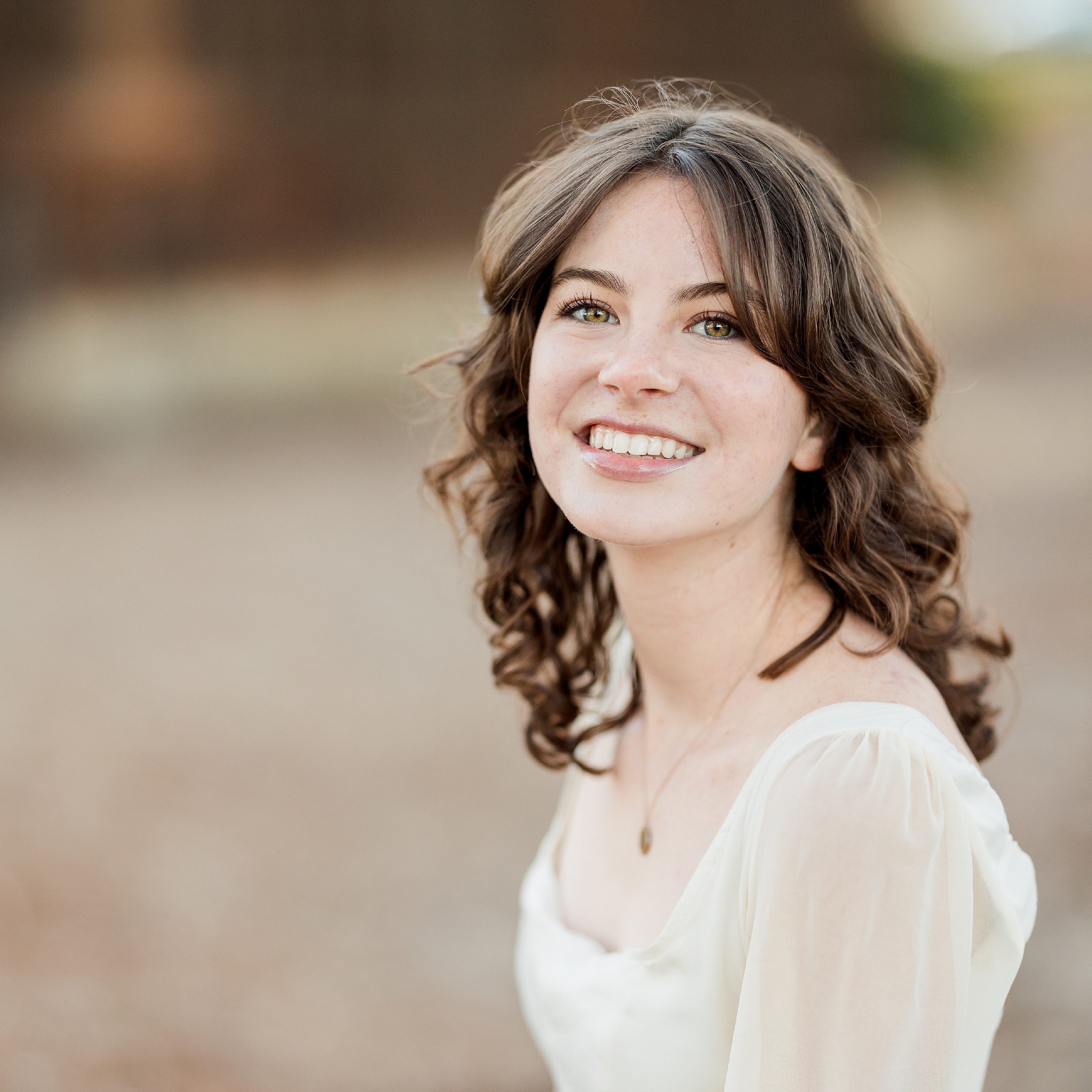 Photographer San Diego — 18 Teen girl in white long-sleeve smiling directly at camera, close-up