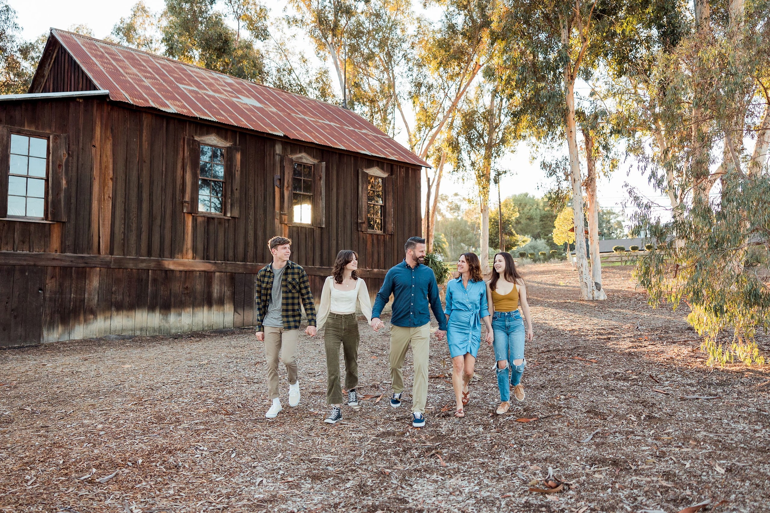 Photographer San Diego — 26 Family of five walking together across the grounds at Town Hall