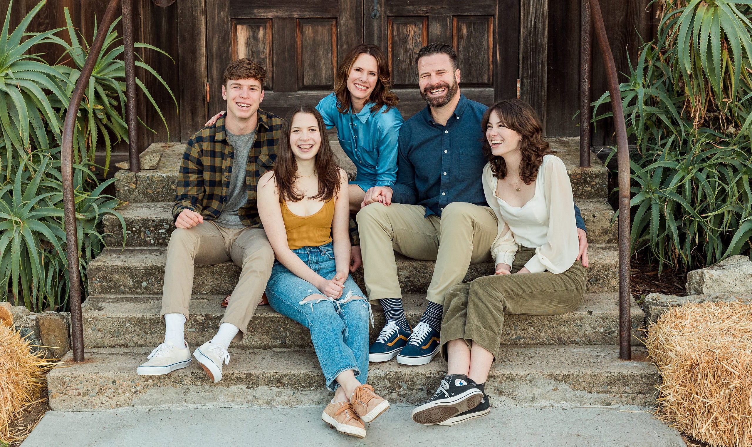 Photographer San Diego — 35 Family of five on stone steps in front of wooden doors at Meeting Hall