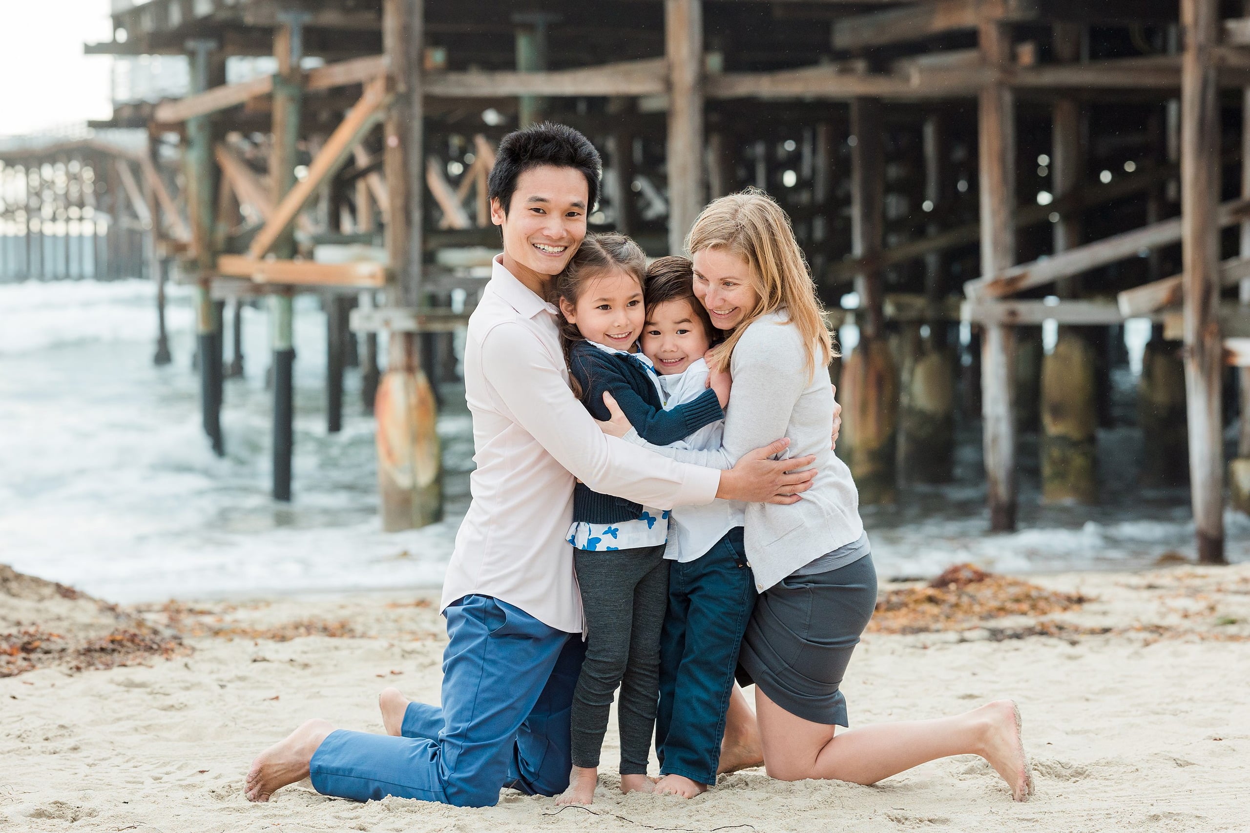 Rainy Day Beach Photo Session — 07 Man with glasses smiles at the camera standing on the beach at Crystal Pier