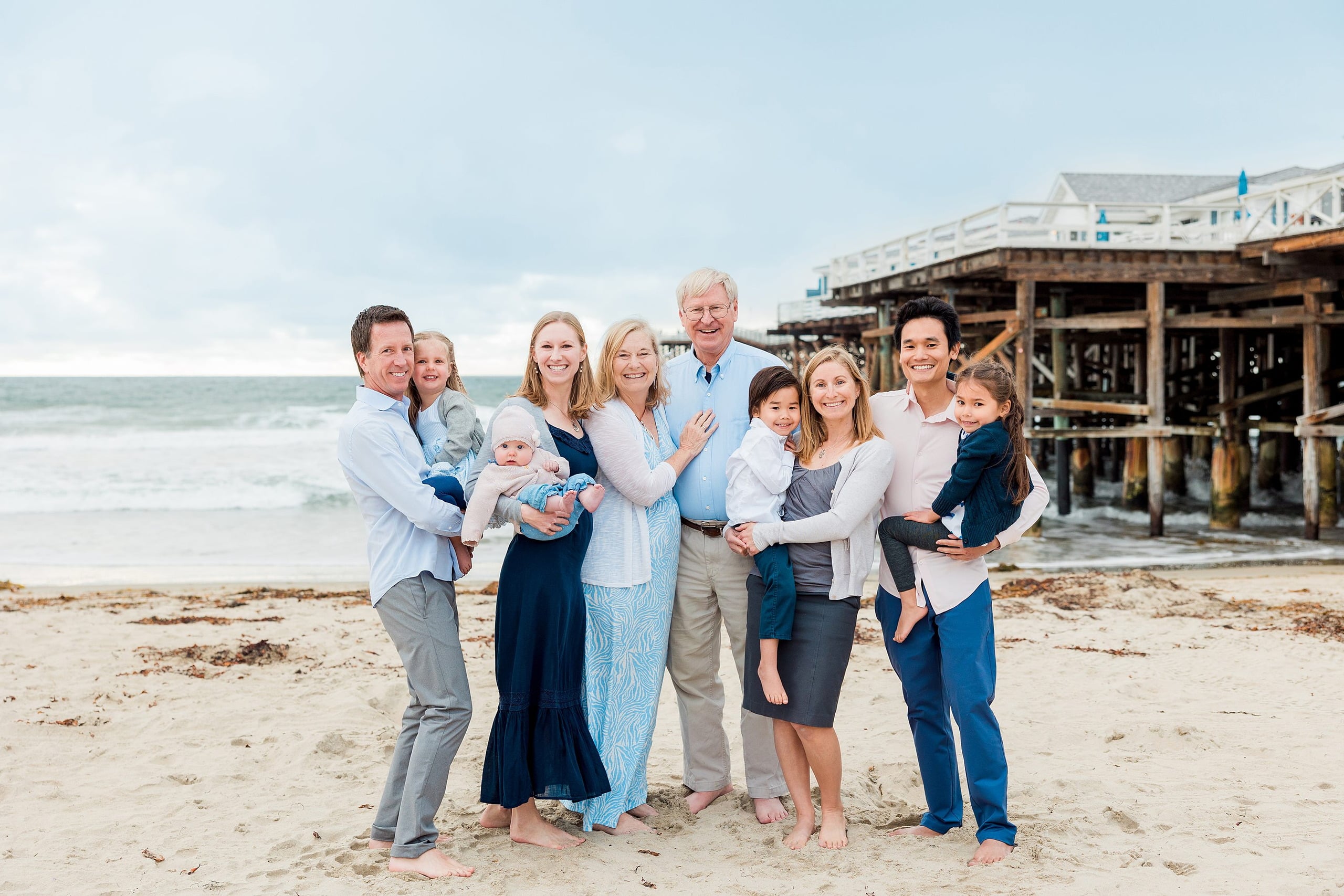 Rainy Day Beach Photo Session — 22 Grandparents and grandchildren stand together in a group on the sand