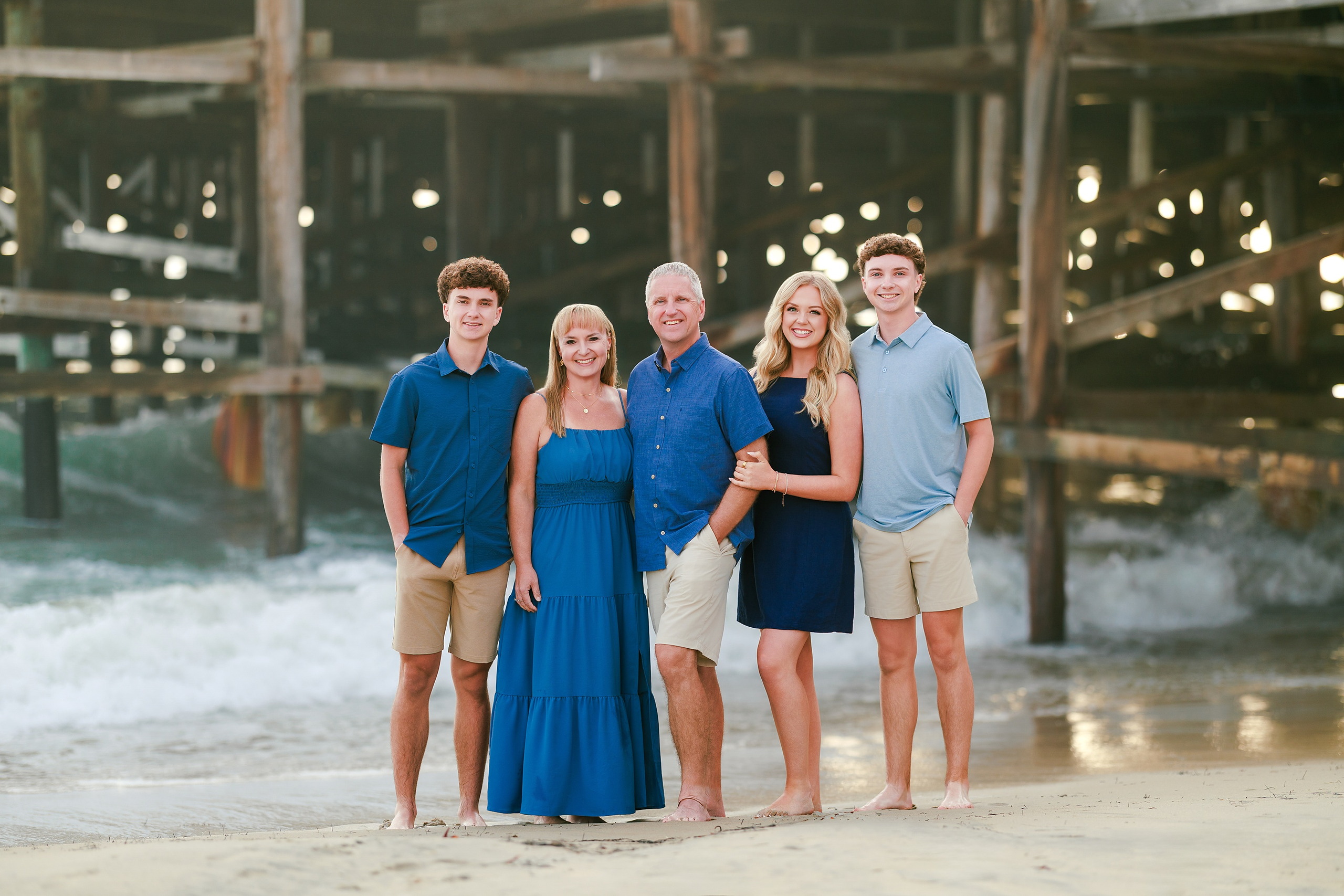 San Diego Beach Family Photos — 01 Family of five standing together on sand near Crystal Pier Pacific Beach
