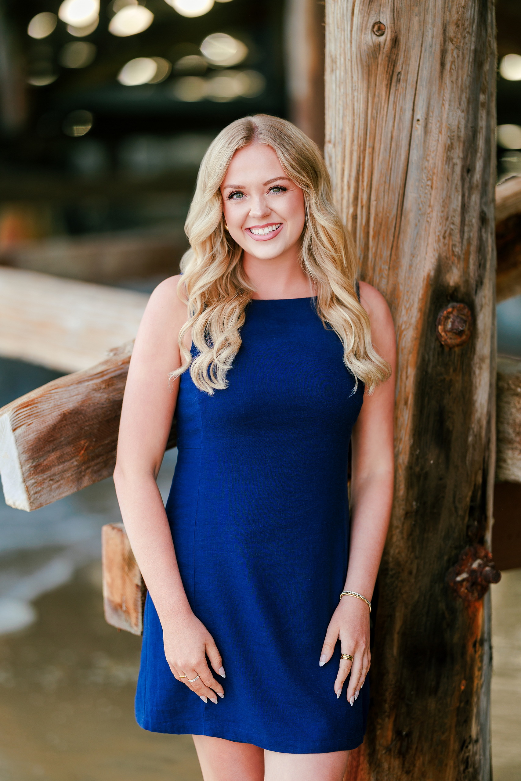 San Diego Beach Family Photos — 03 Young woman in blue dress standing by pier at Crystal Pier