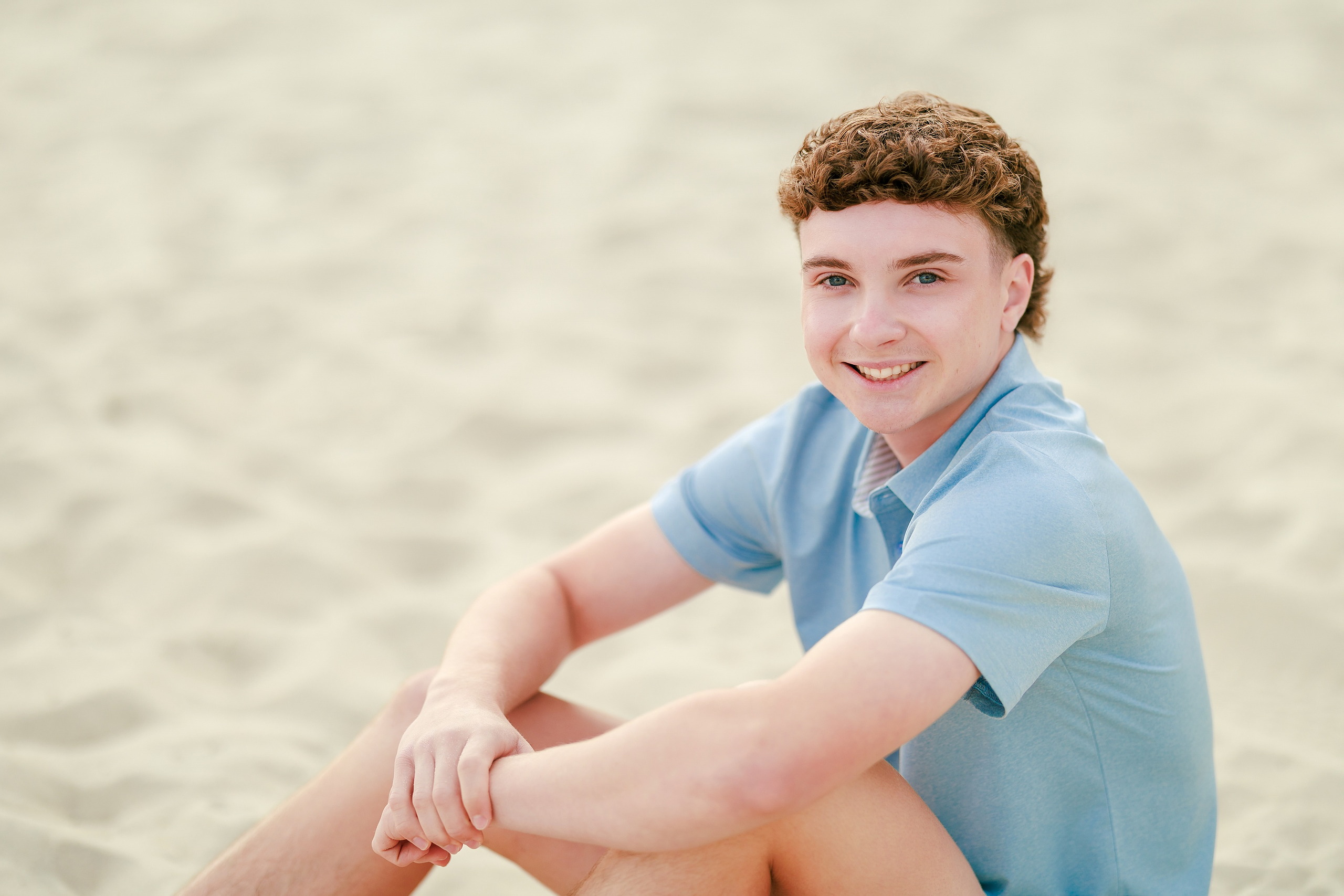 San Diego Beach Family Photos — 12 Teen boy in dark blue shirt standing on beach, smiling at camera