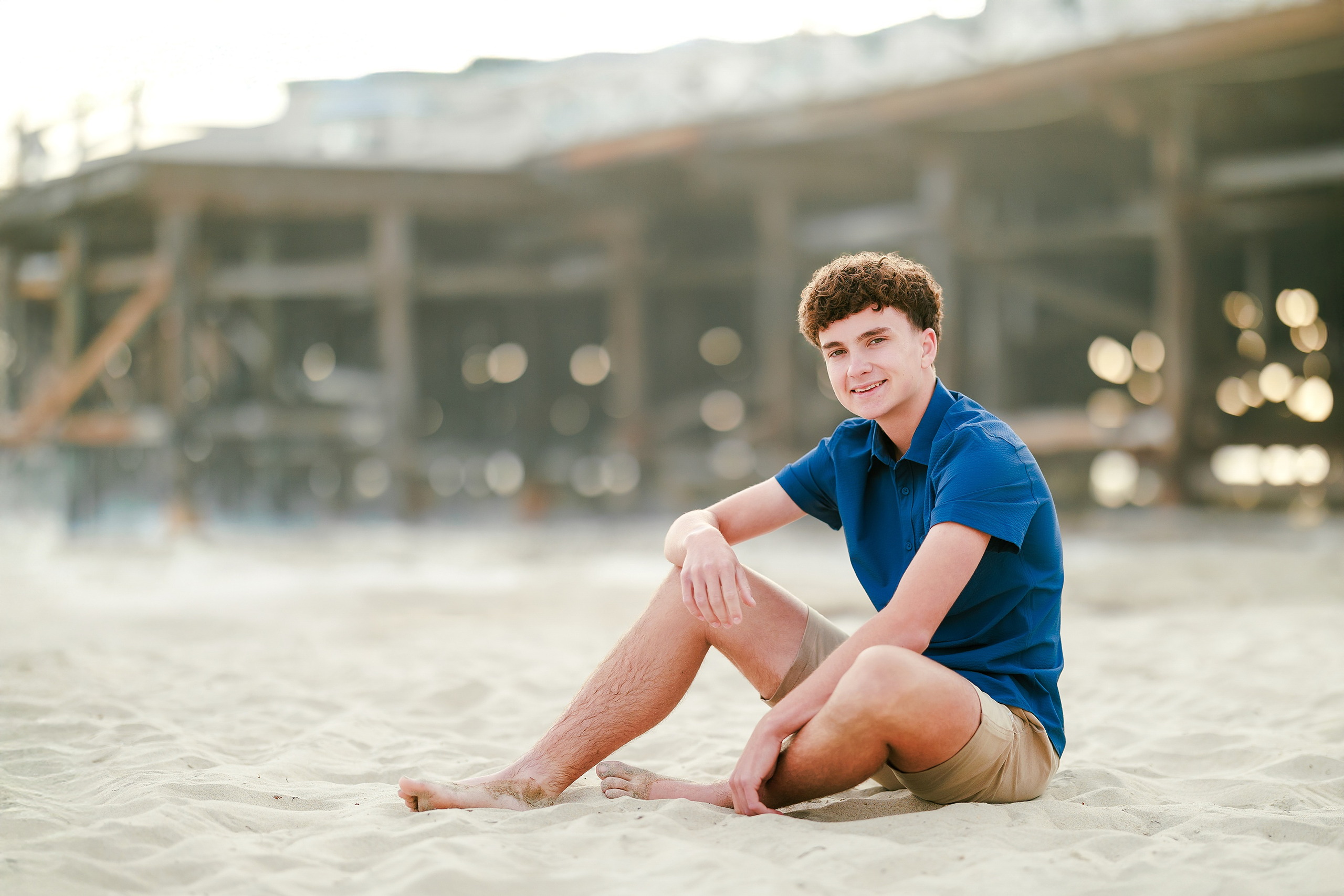 San Diego Beach Family Photos — 13 Teen boy in blue shirt standing on wet sand at shoreline