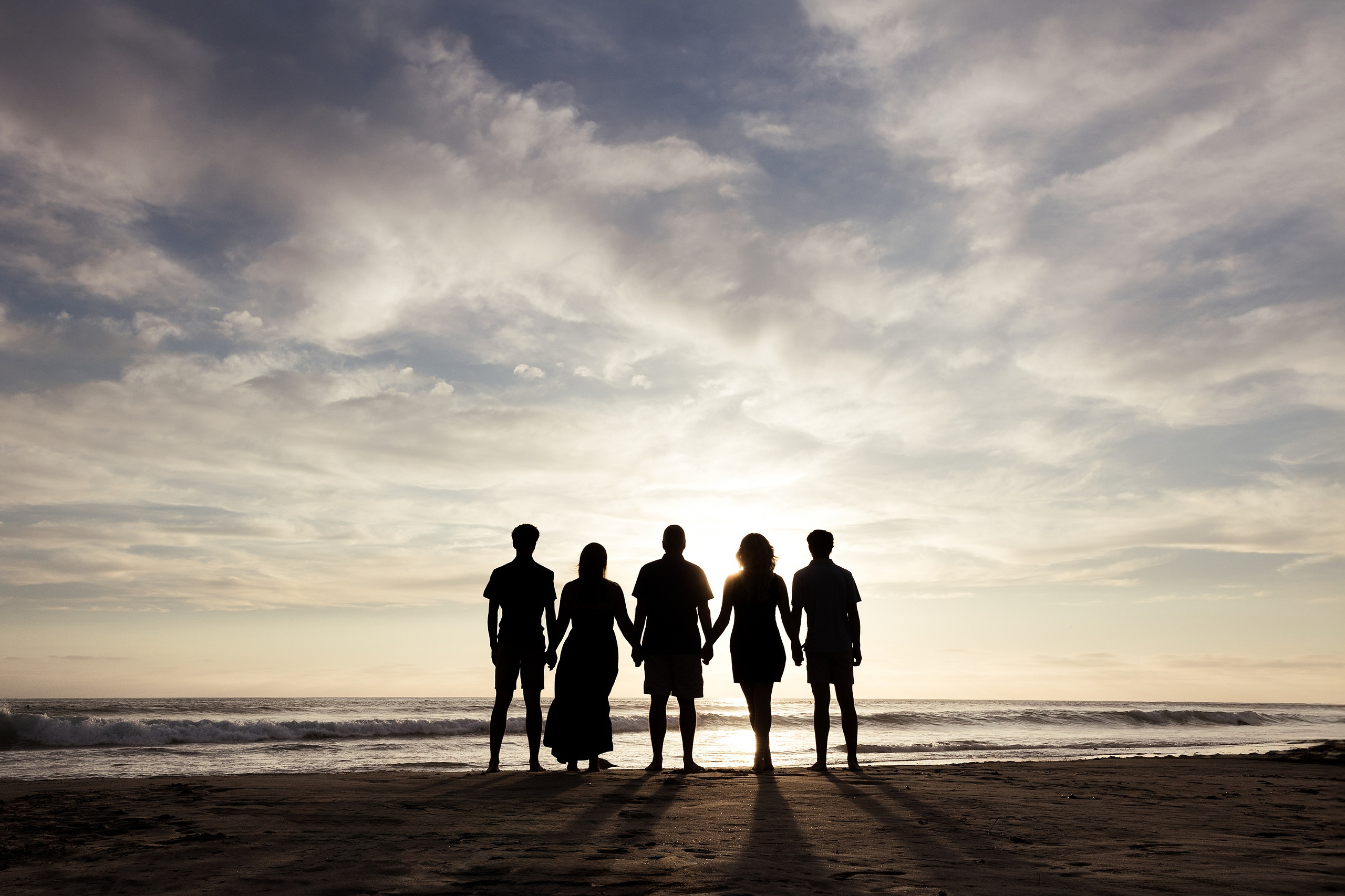 San Diego Beach Family Photos — 15 Family of five holding hands silhouetted against ocean at sunset