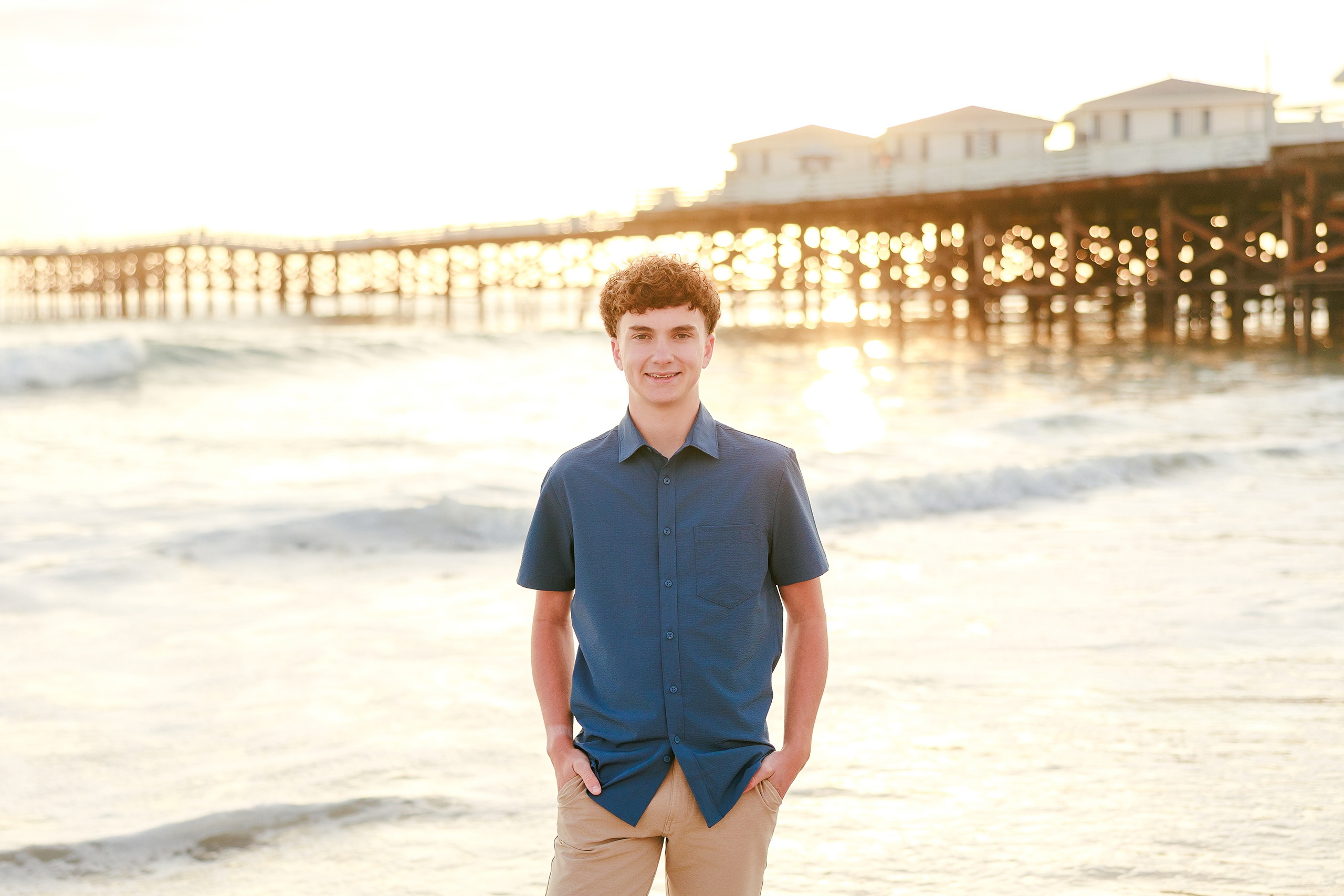San Diego Beach Family Photos — 21 Teen in blue shirt standing on beach gazing toward the ocean