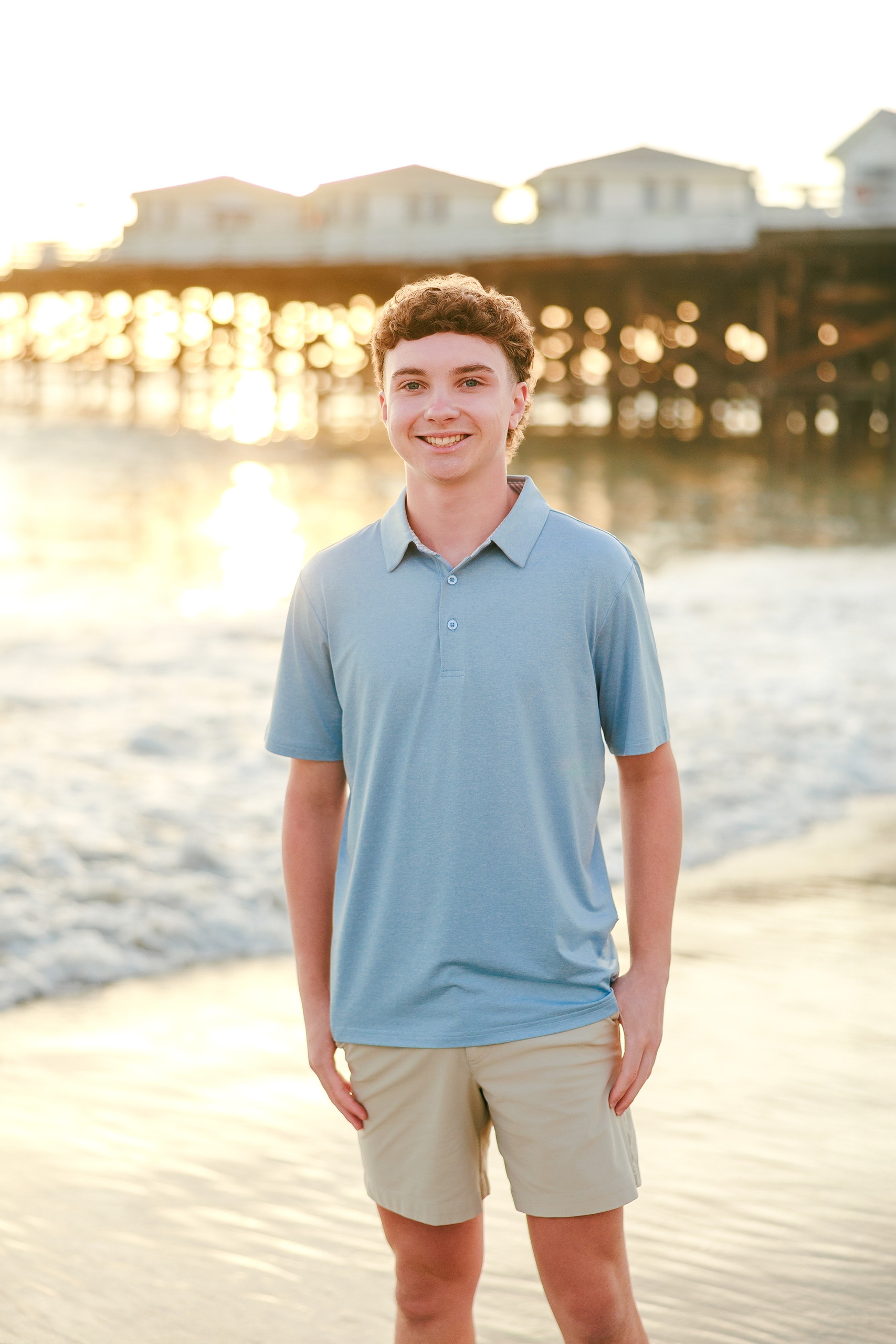 San Diego Beach Family Photos — 23 Teen in light blue polo at beach, relaxed portrait at shoreline