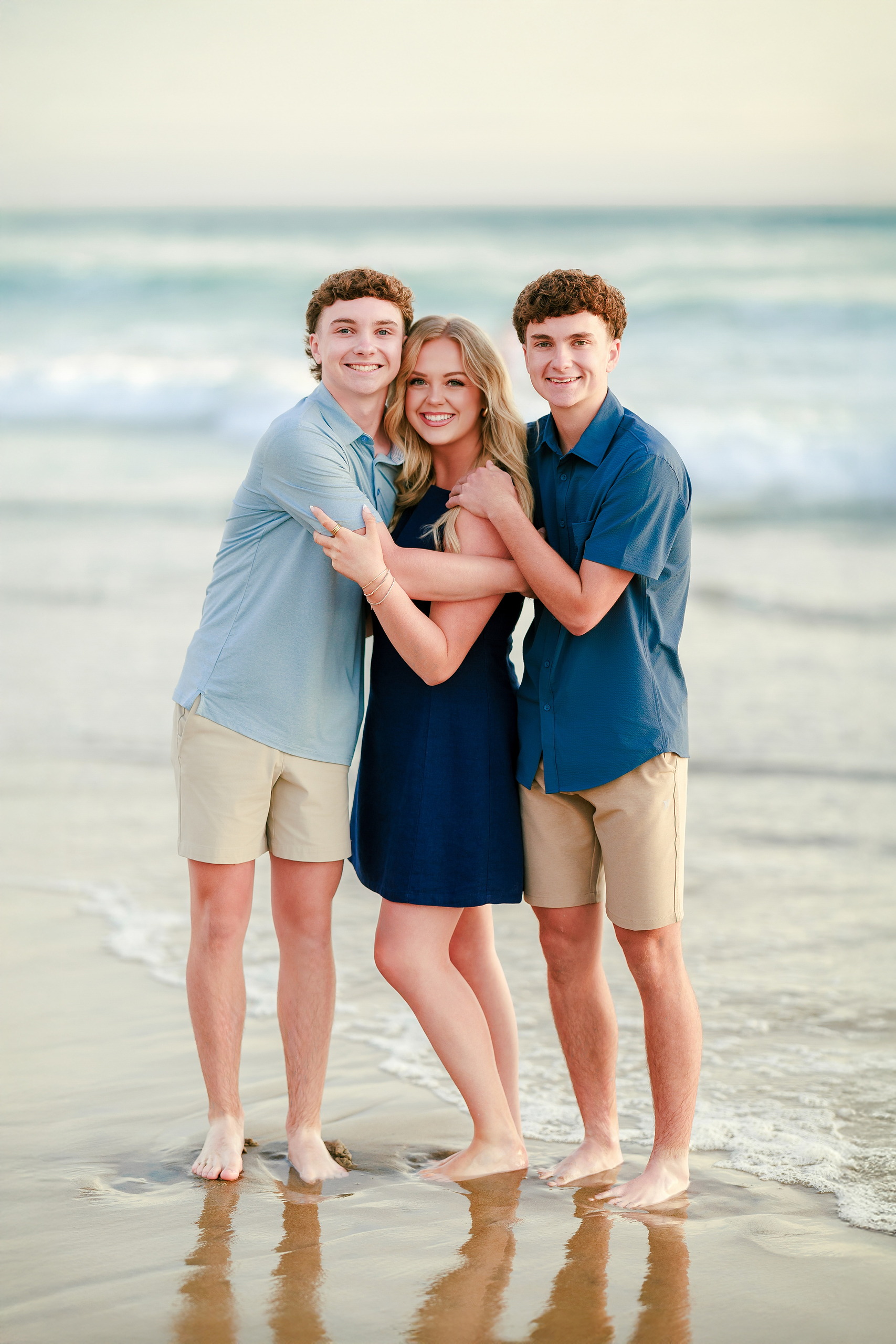San Diego Beach Family Photos — 27 Adult woman and young adult holding each other close on beach