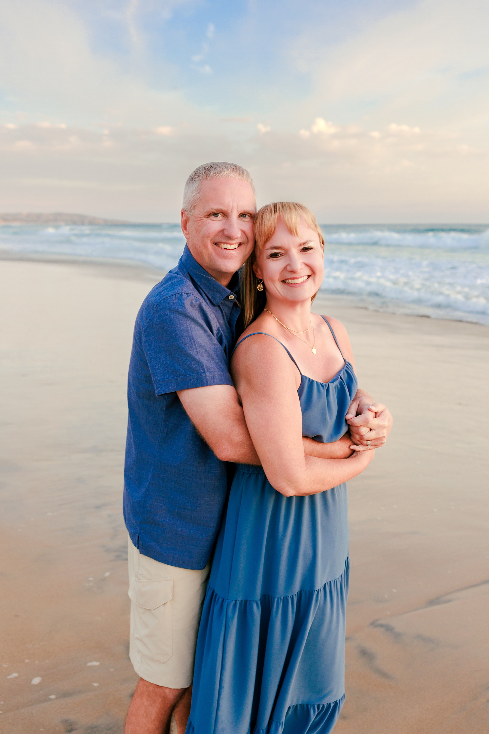 San Diego Beach Family Photos — 29 Man and woman holding hands walking on wet sand at shoreline