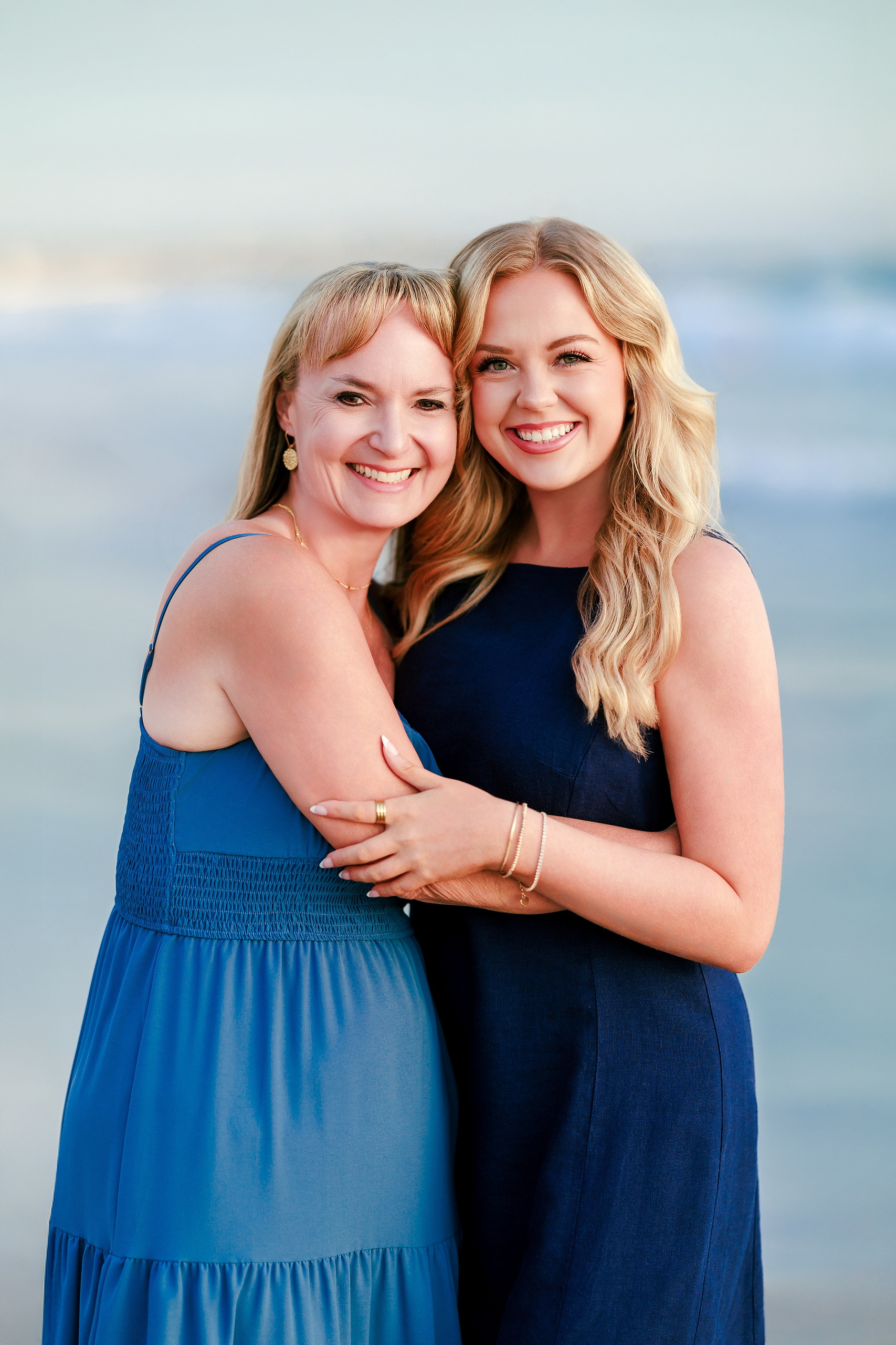 San Diego Beach Family Photos — 30 Adult woman and young adult embracing on beach at shoreline