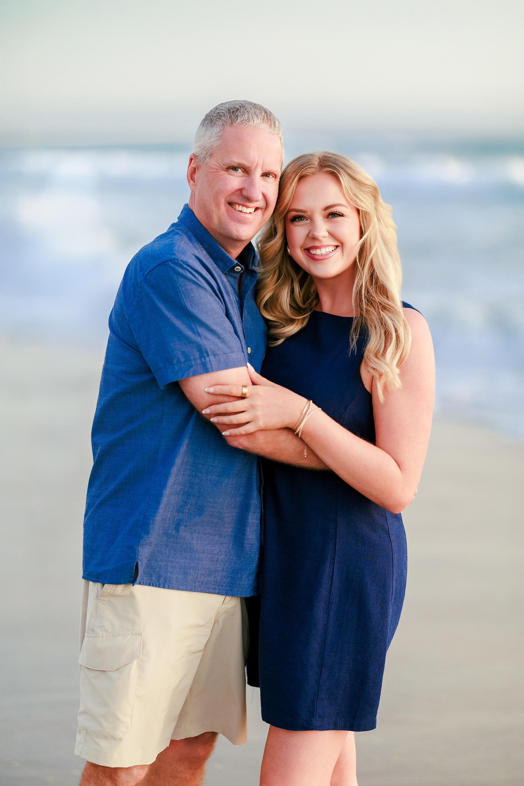 San Diego Beach Family Photos — 31 Couple embracing on wet sand with ocean waves behind them