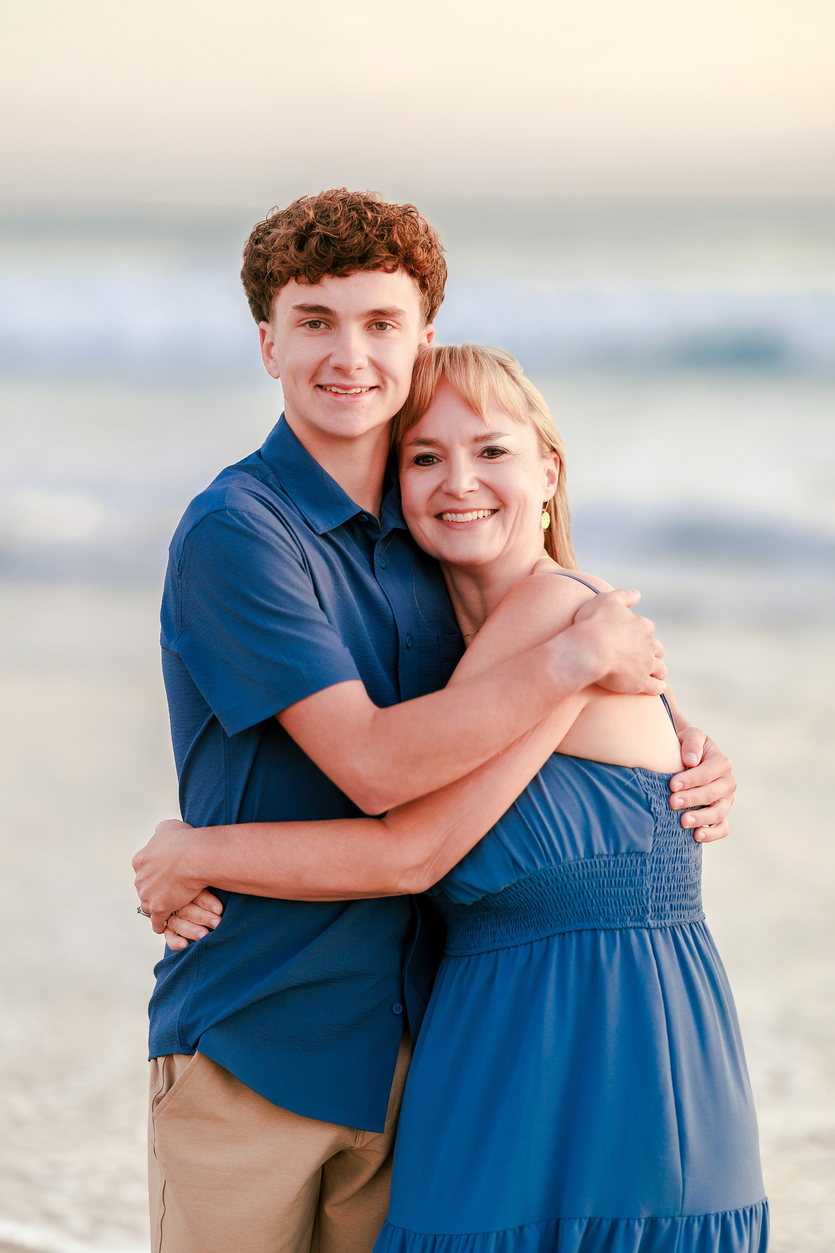 San Diego Beach Family Photos — 36 Adult woman and young woman standing close together on beach