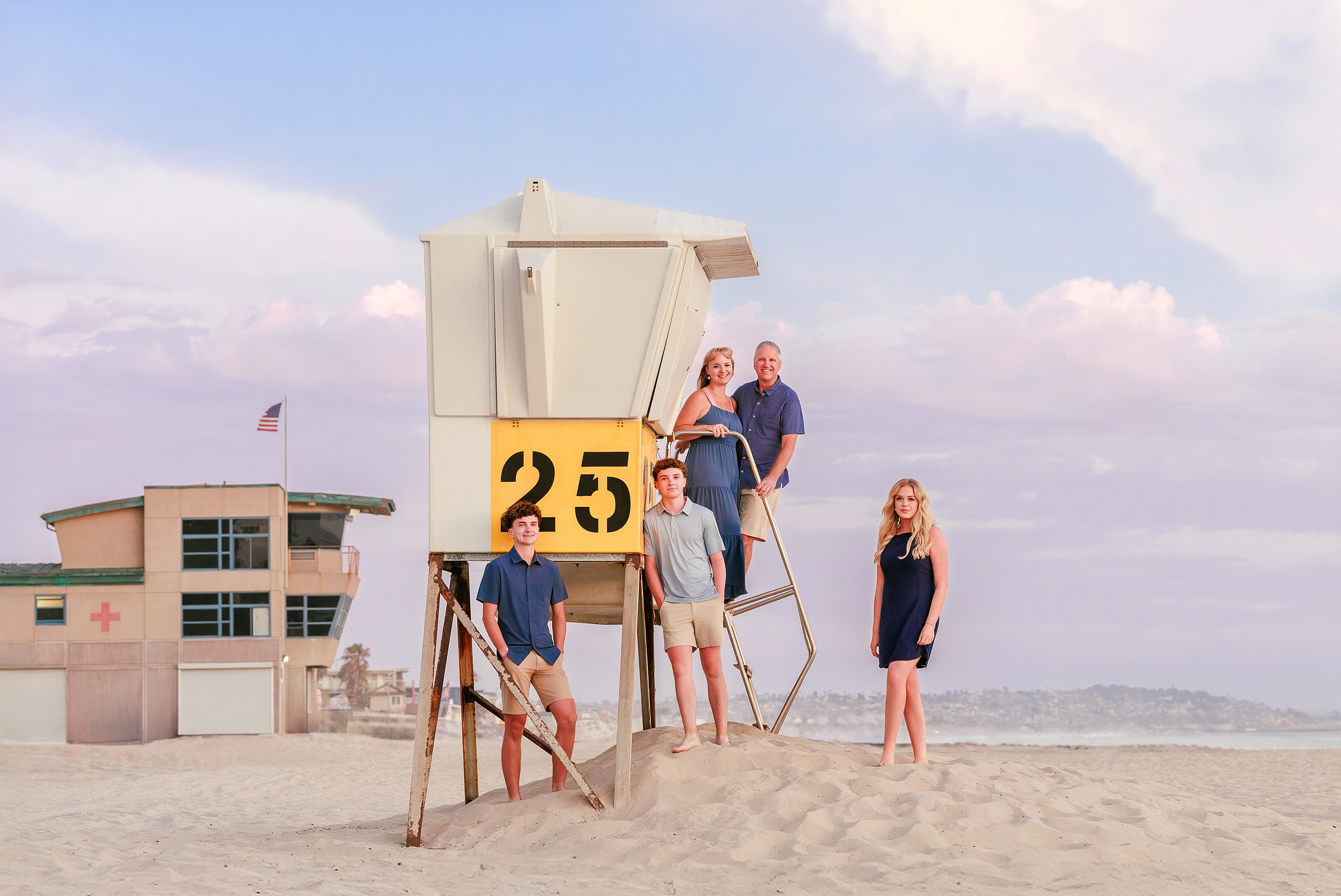 San Diego Beach Family Photos — 40 Silhouette of person jumping from lifeguard stand against sunset sky