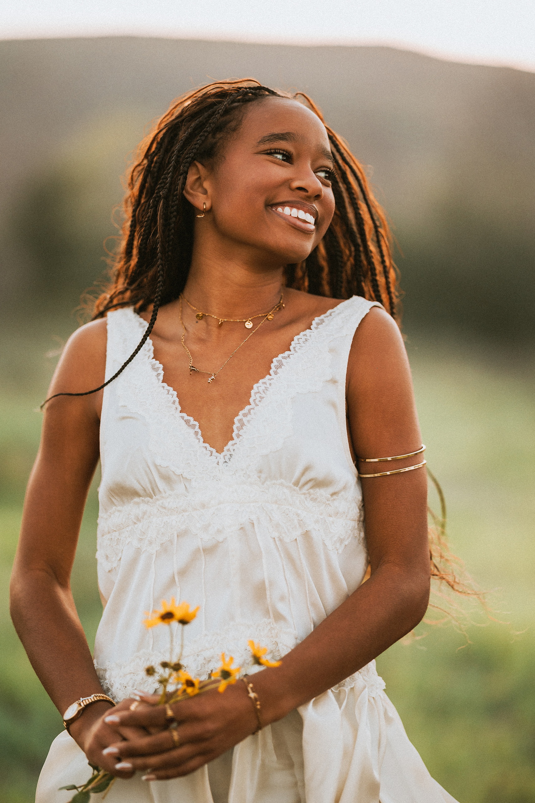 San Diego Senior Photos — 08 Kaelyn in white dress holding yellow flowers, backlit by golden hour light